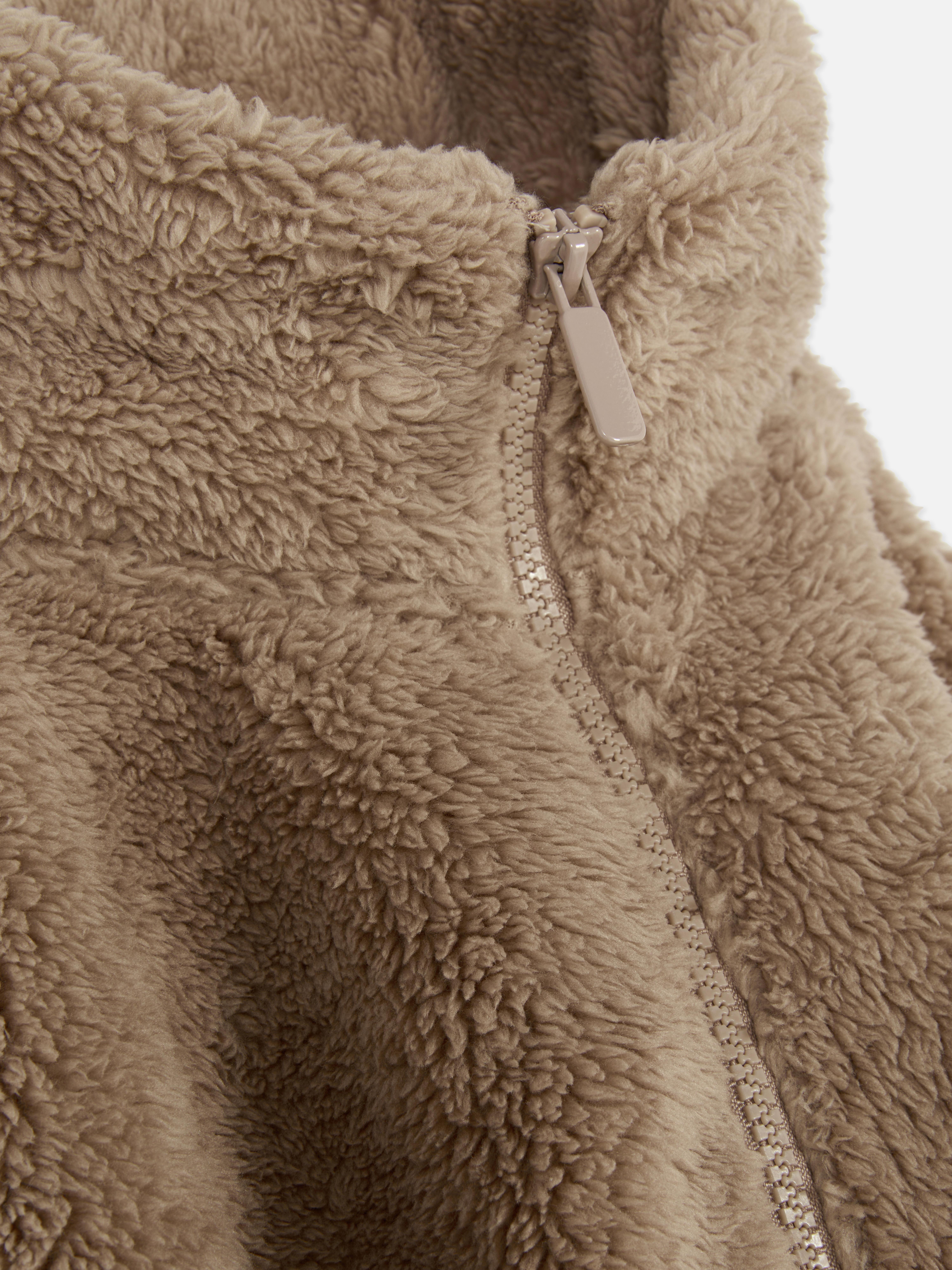 Teddy fleece zippered jacket. A soft teddy fleece jacket with long sleeves, a stand-up collar, and a full-length zipper.