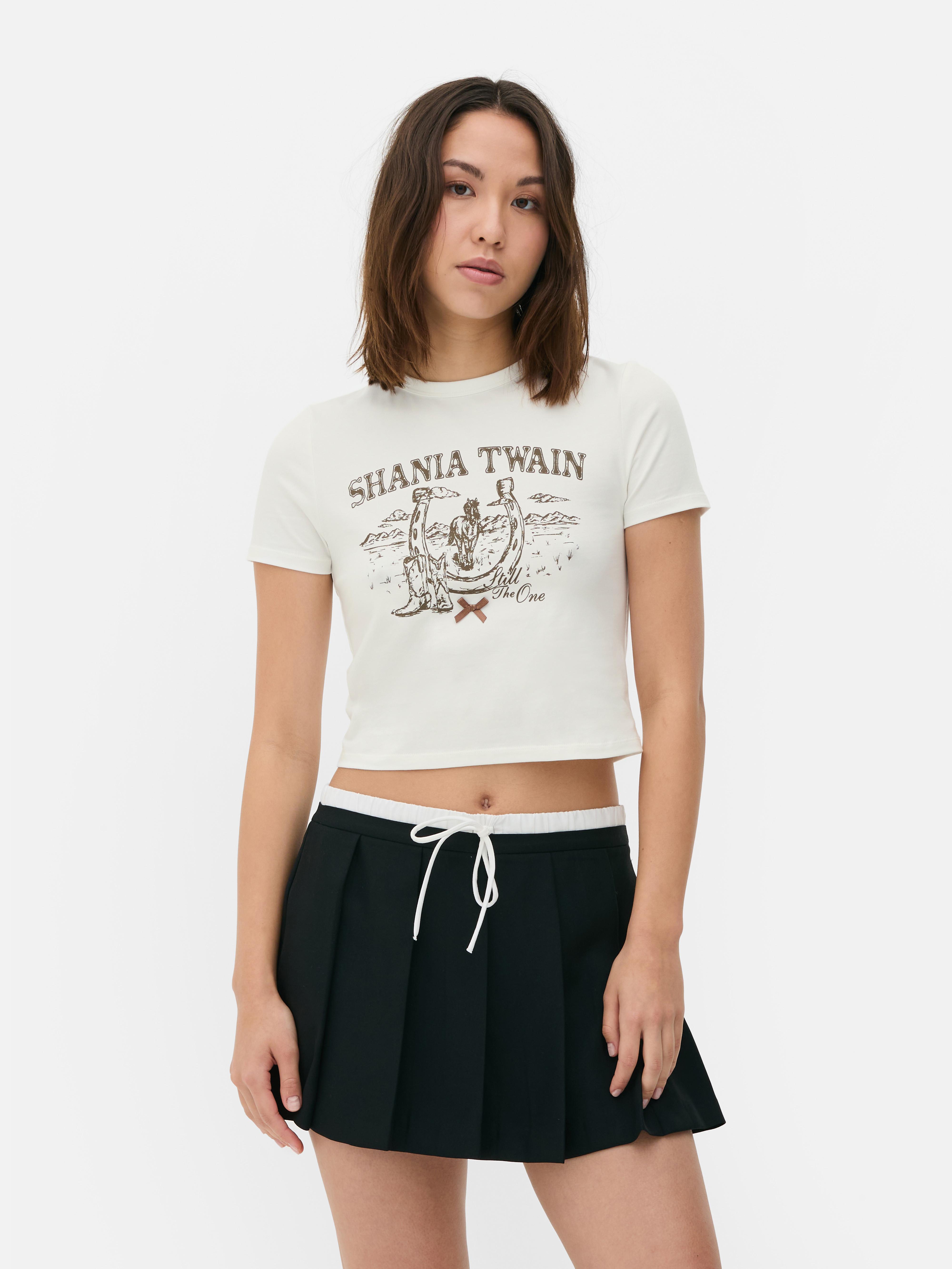 Tricou pentru bebeluși Shania Twain Un tricou pentru bebeluși cu mânecă scurtă și imprimeu Shania Twain