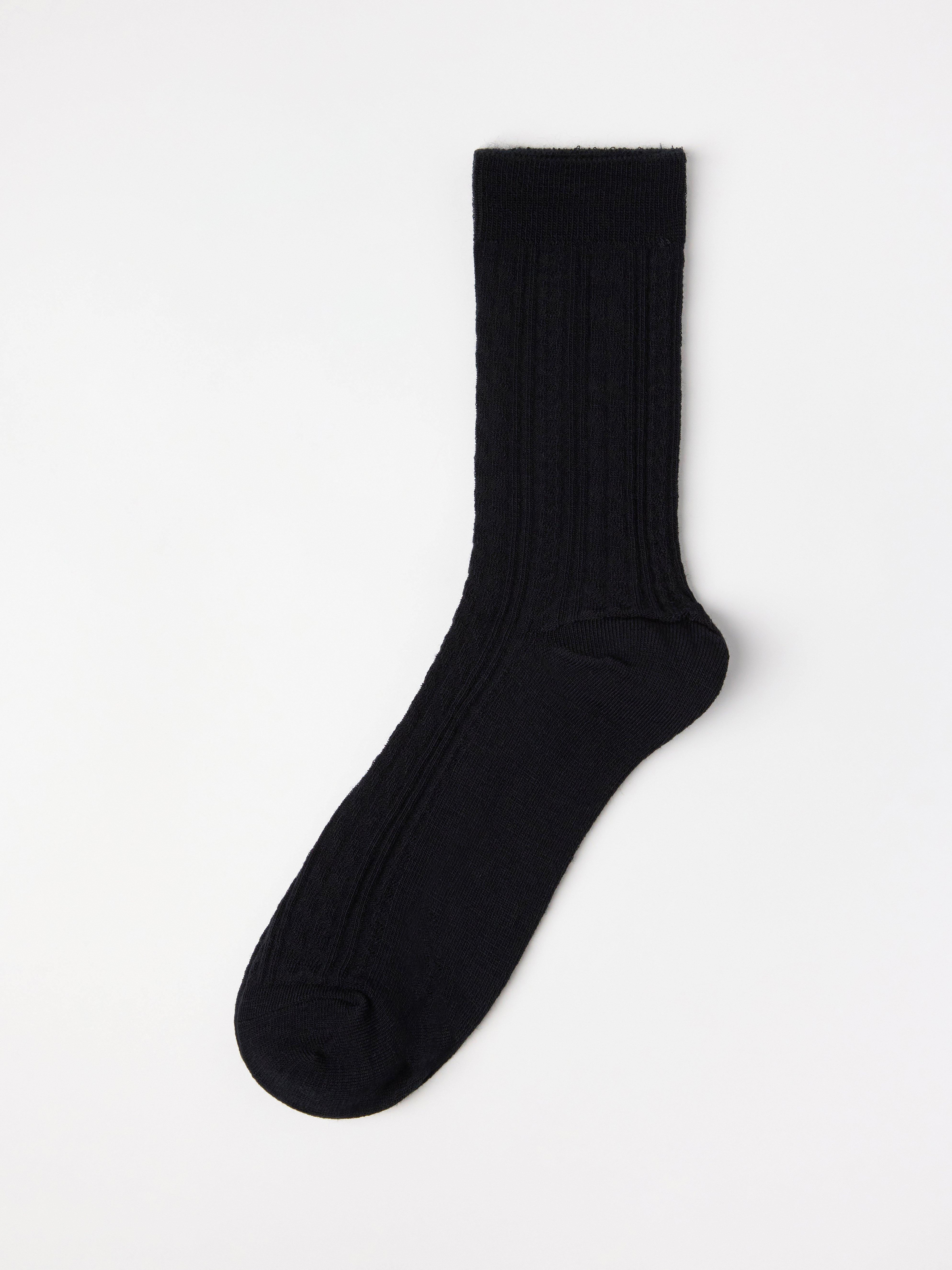 Calcetines de punto trenzado en mezcla de lana merino, color negro.