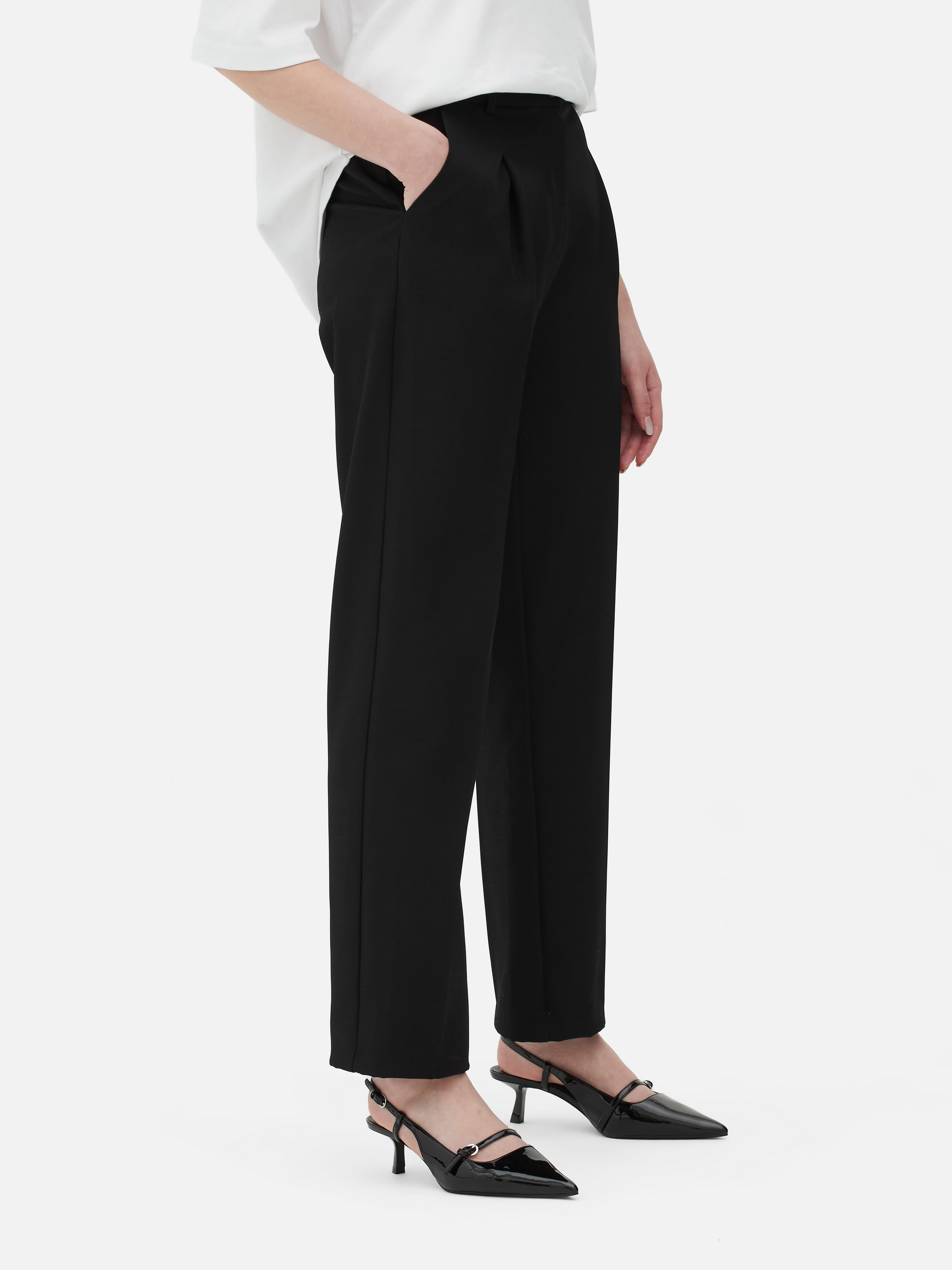 Passende Hose mit geradem Bein. Eine minimalistische Hose mit Bundfalten, geradem Schnitt und neutraler Farbe.