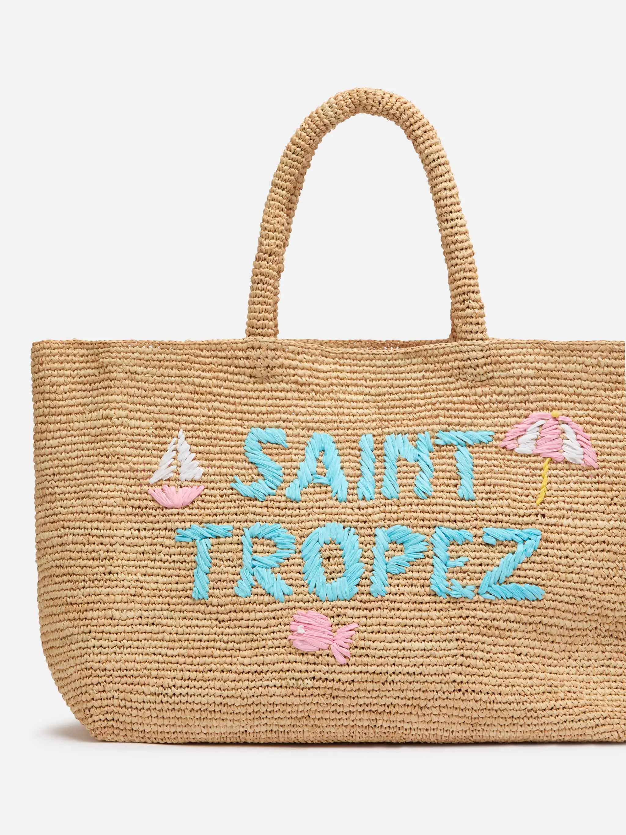 Beige raffia strandtas met katoenen binnenvak en St. Trop-borduurwerk.