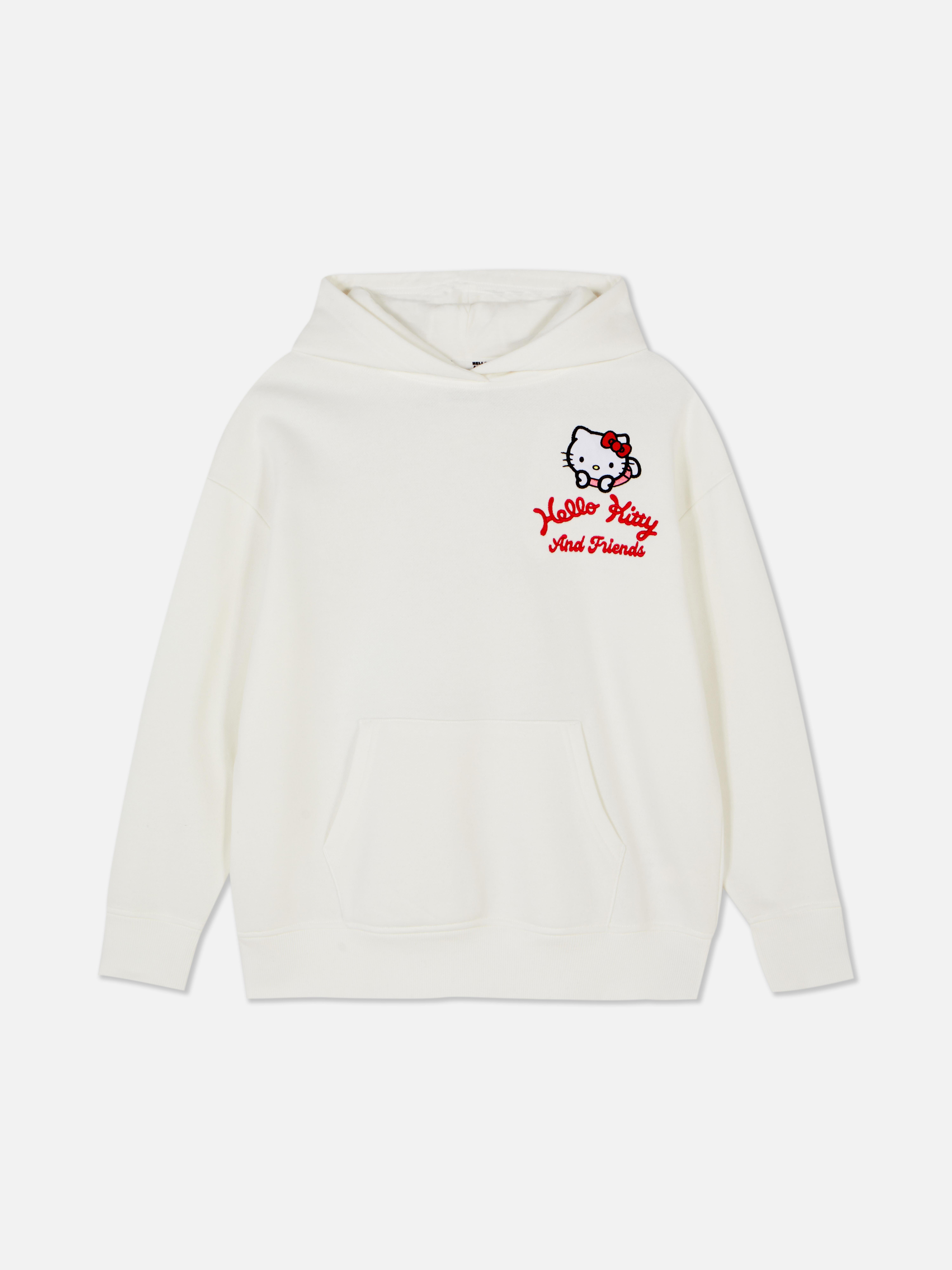 Felpa con cappuccio coordinata con stampa di Hello Kitty e amici. Una felpa con cappuccio dotata di tasca a marsupio, polsini a coste e design Sanrio.