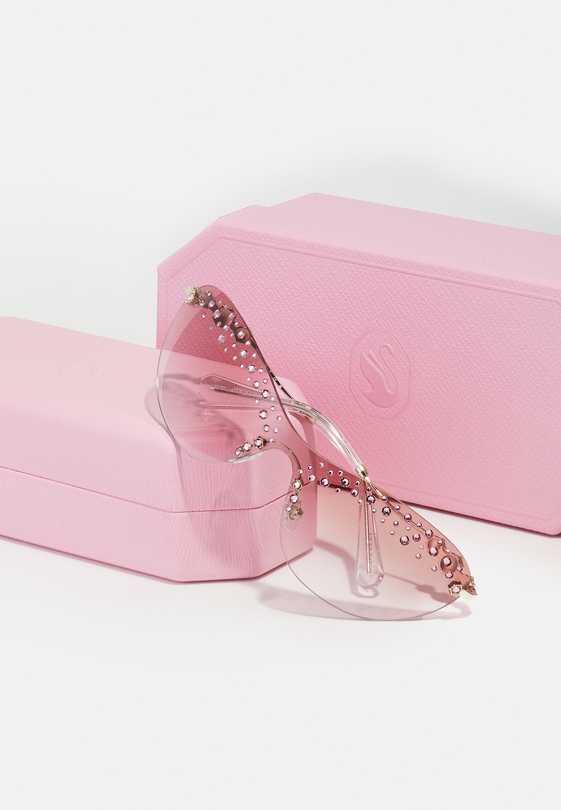 Okulary przeciwsłoneczne Swarovski – jasnozłote/przezroczysty gradientowy róż