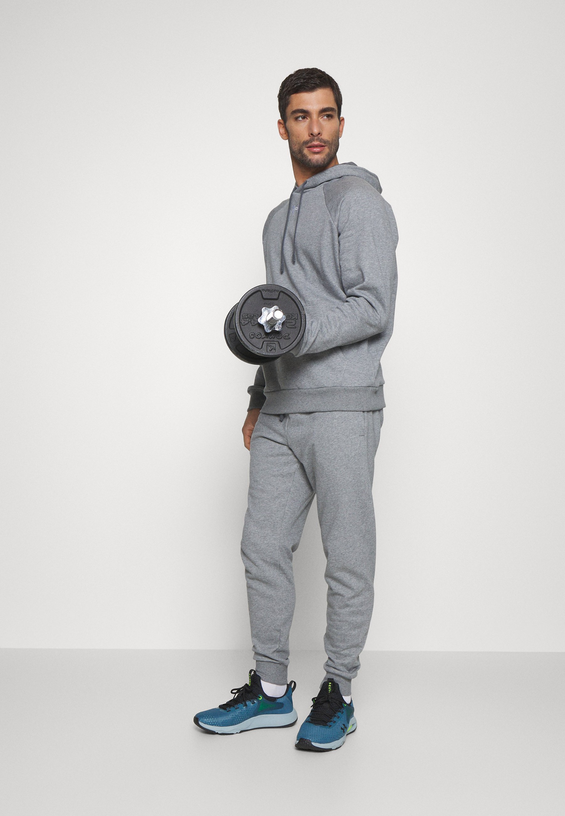 Pantaloni da tuta Under Armour RIVAL FLEECE - colore grigio chiaro melange/bianco