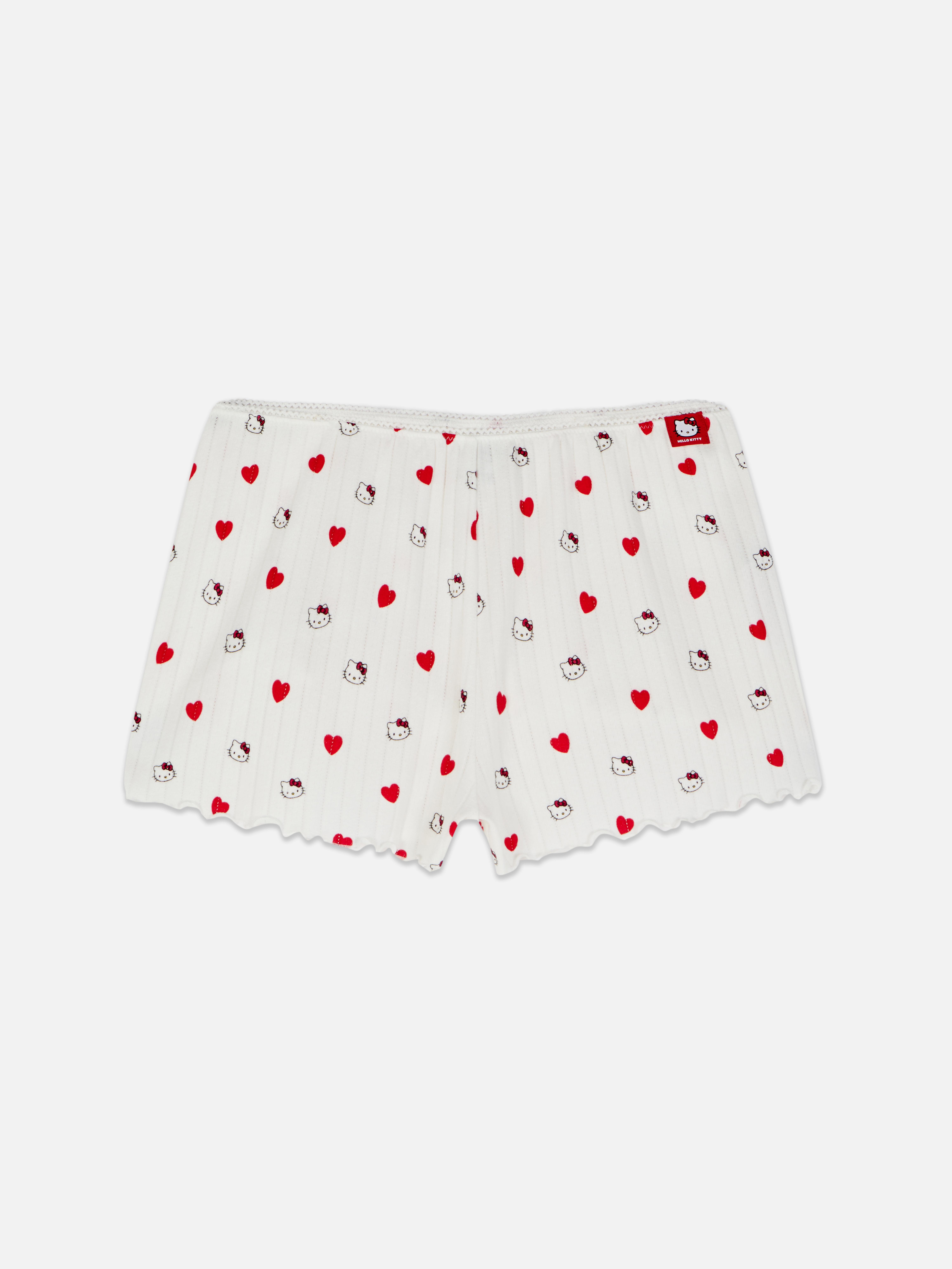 Pantaloni scurți de pijama Hello Kitty cu motive ajurate. Un pantaloni scurți de pijama moi cu motive ajurate, decorați cu motive Hello Kitty.