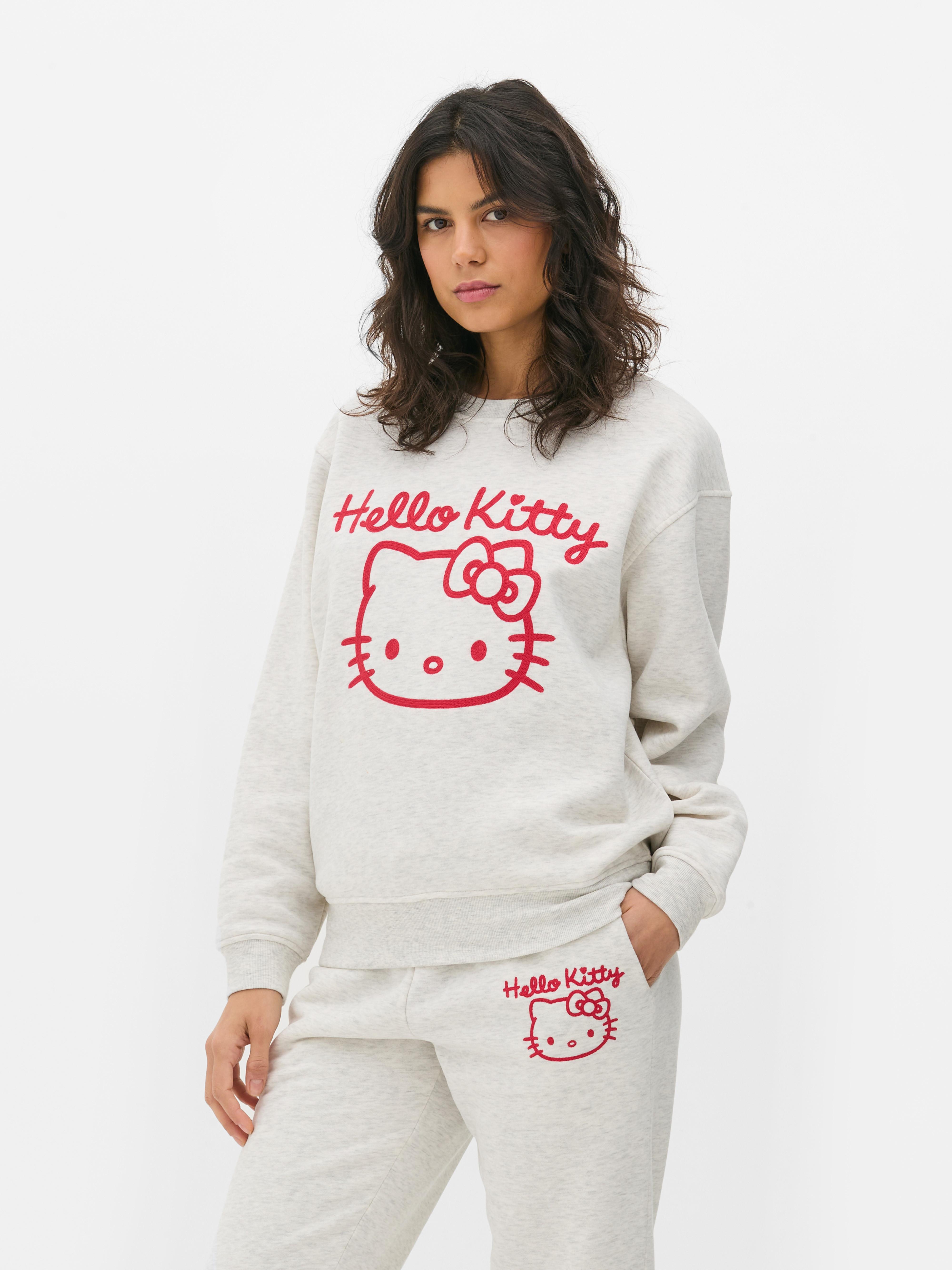 Hanorac cu imprimeu Hello Kitty Un hanorac cu umeri căzuți, manșete cu nervuri și imprimeu Hello Kitty