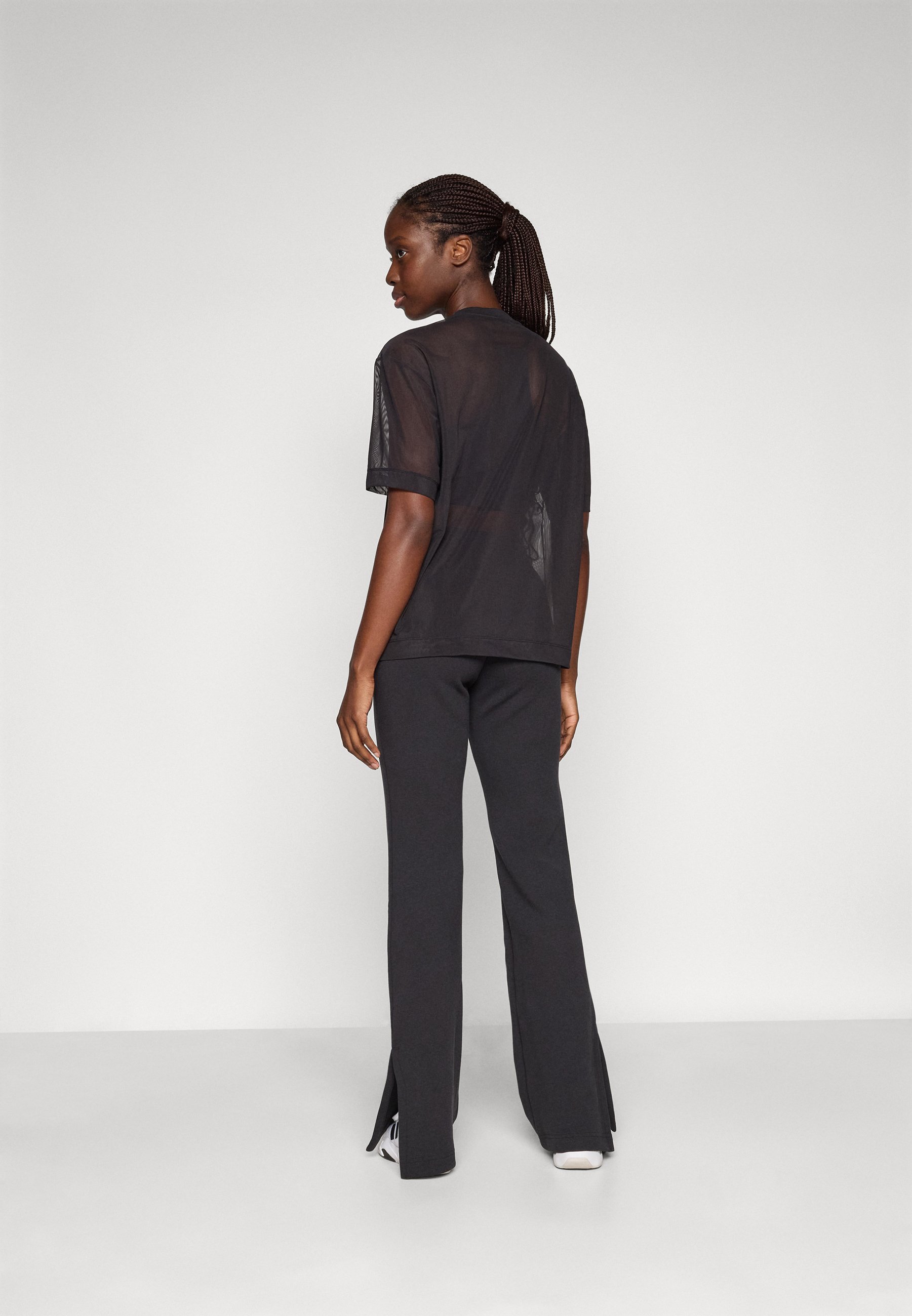 adidas Sportswear SOFT LUX FLARED PANTS - Legginsy - czarne