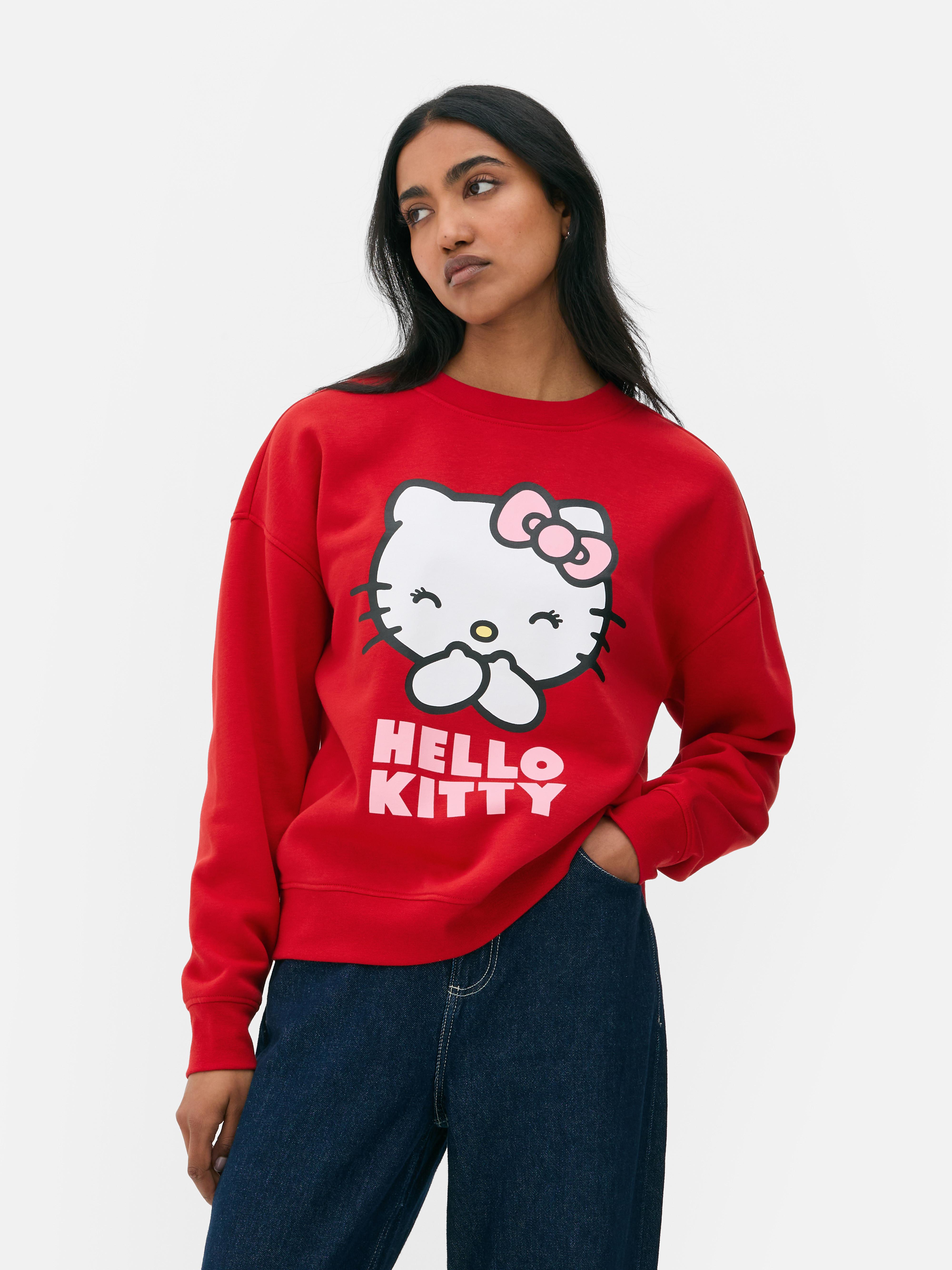 Дуксерица са принтом Hello Kitty Шарена дуксерица Hello Kitty са округлим изрезом и дугим рукавима