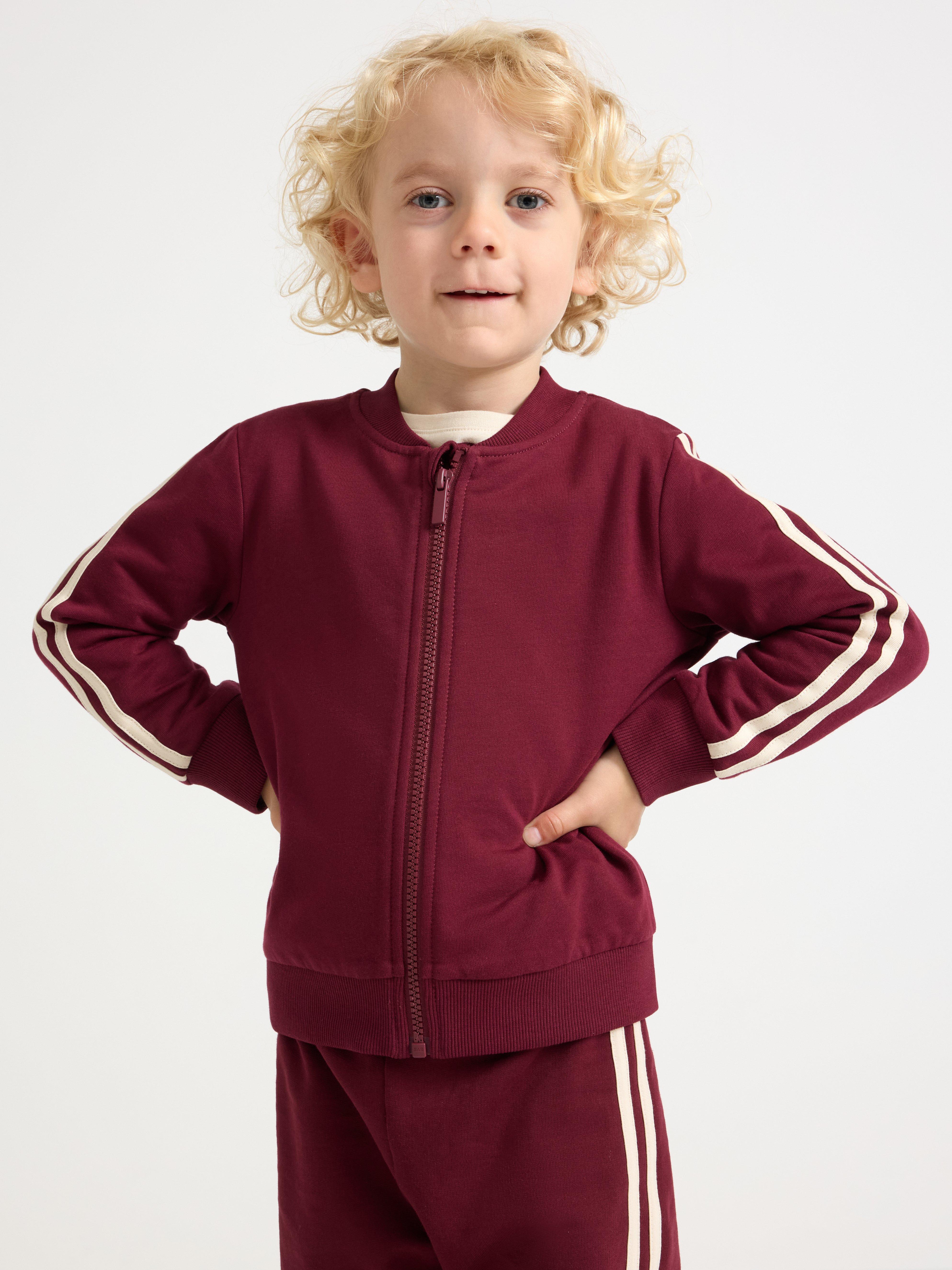 Sudadera con cremallera, color rojo oscuro empolvado.