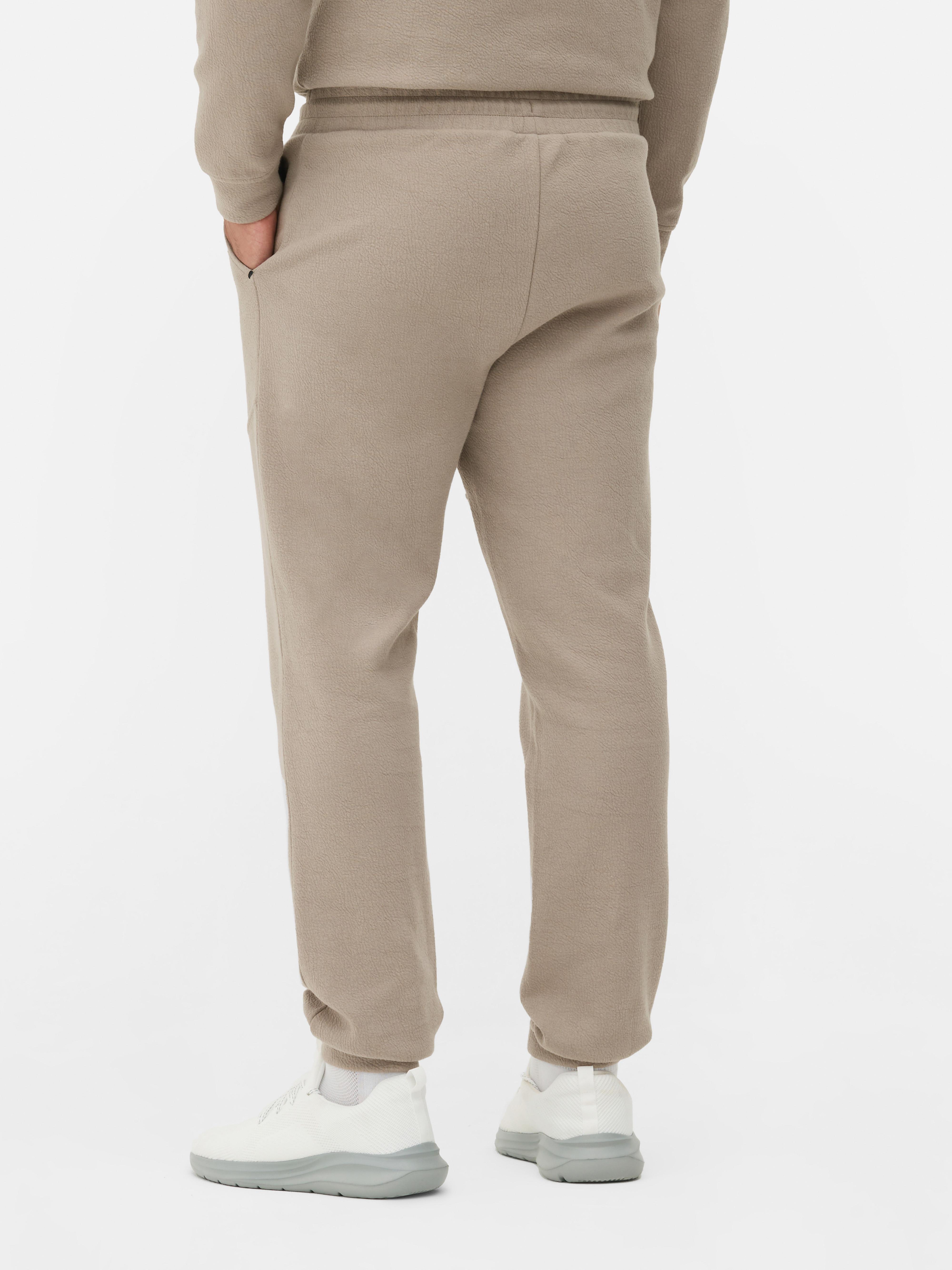Pantaloni de trening texturați cu șnur de strângere Pantaloni de trening cu șnur de strângere, buzunare laterale, clinuri și manșete la gleznă