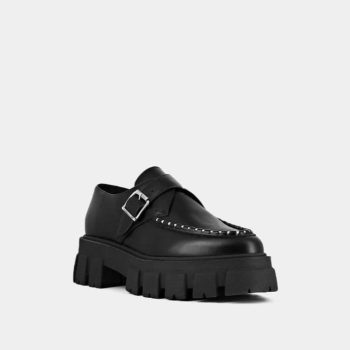 Mocassins à semelles crantées et détails...  en cuir glacé noir