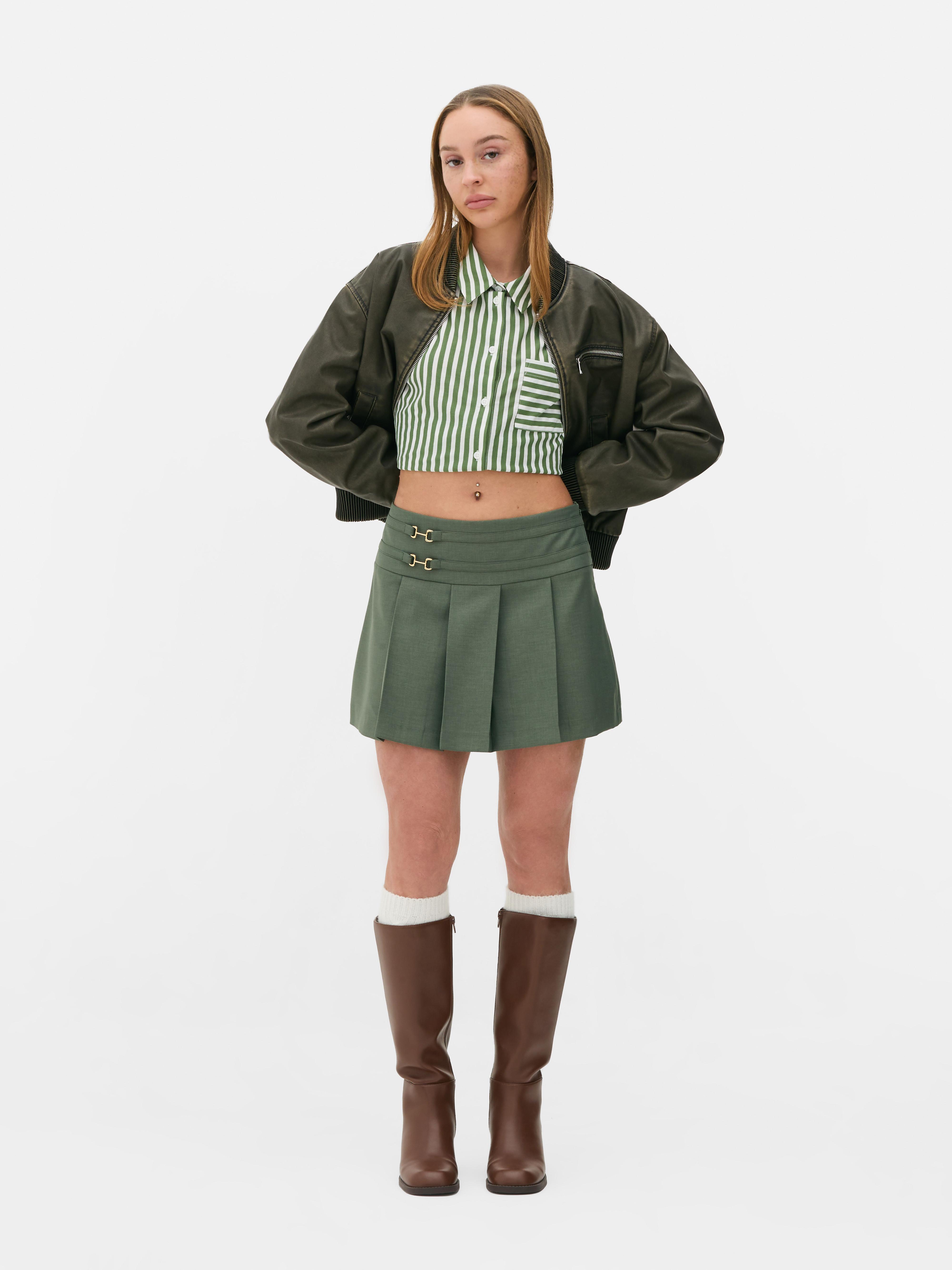 Pleated mini skirt A pleated mini skirt with metallic bit details