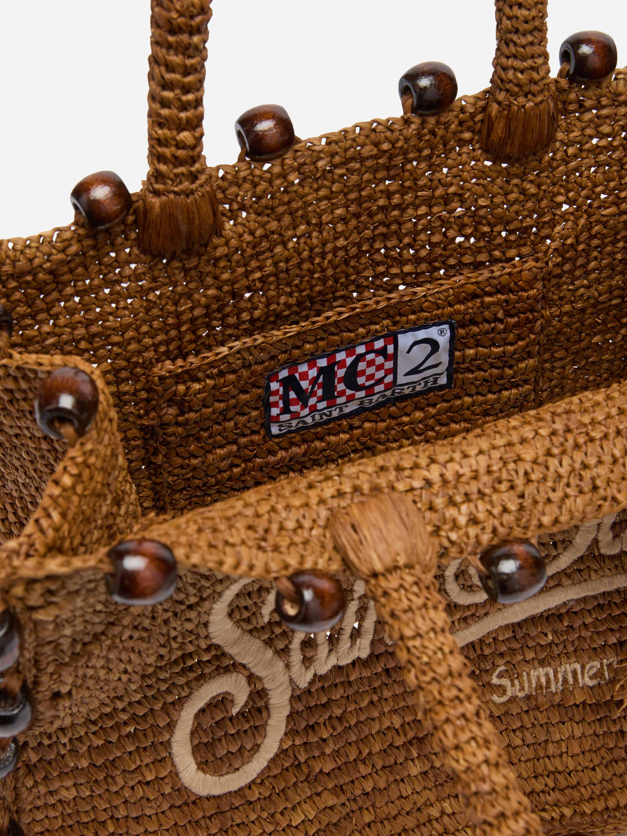 Colette tas van bruin raffia met kralen en geborduurd logo.