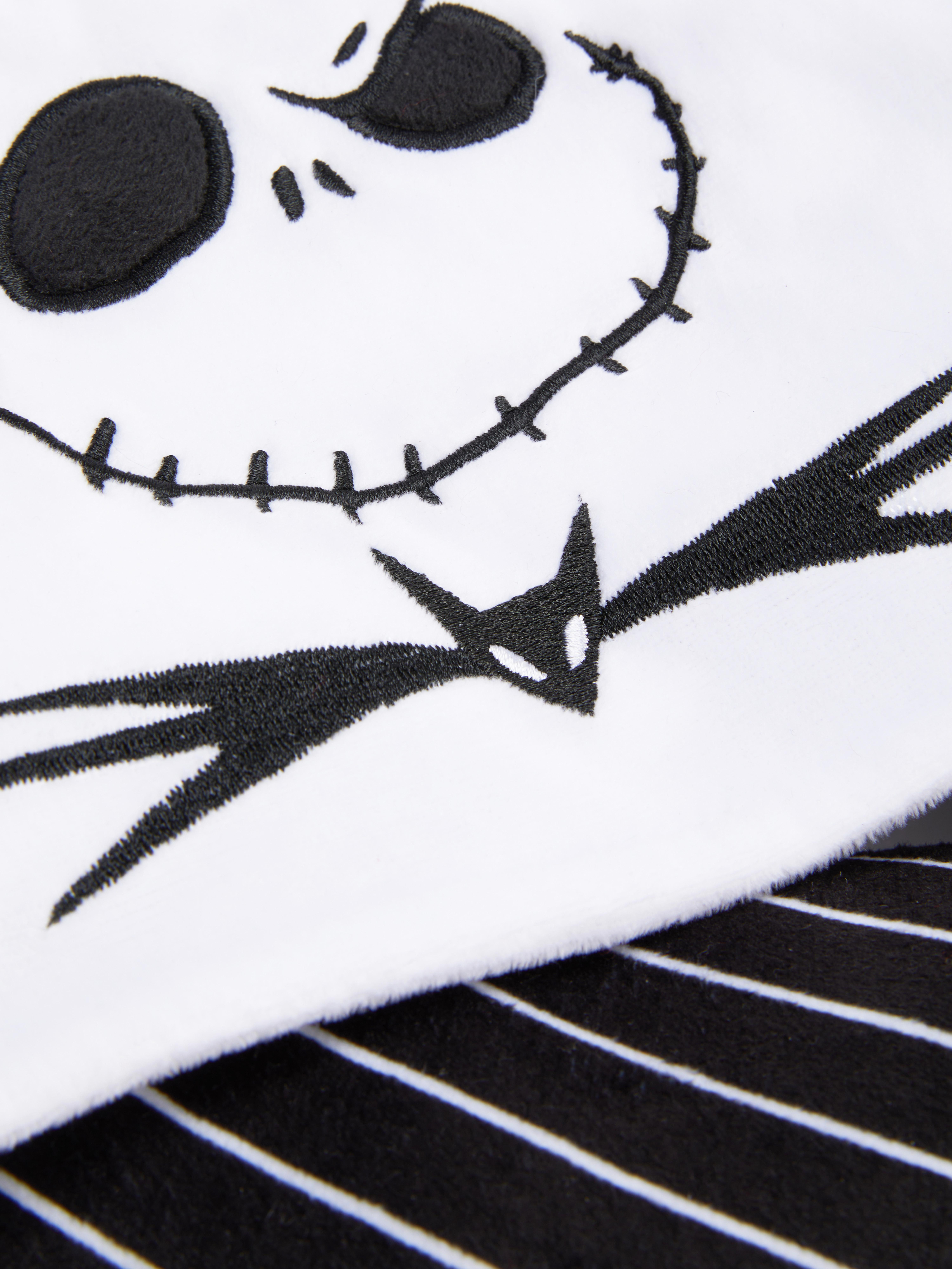 Pernă de călătorie Disney Tim Burton Coșmarul dinaintea Crăciunului O pernă de călătorie cu glugă cu design Jack Skellington