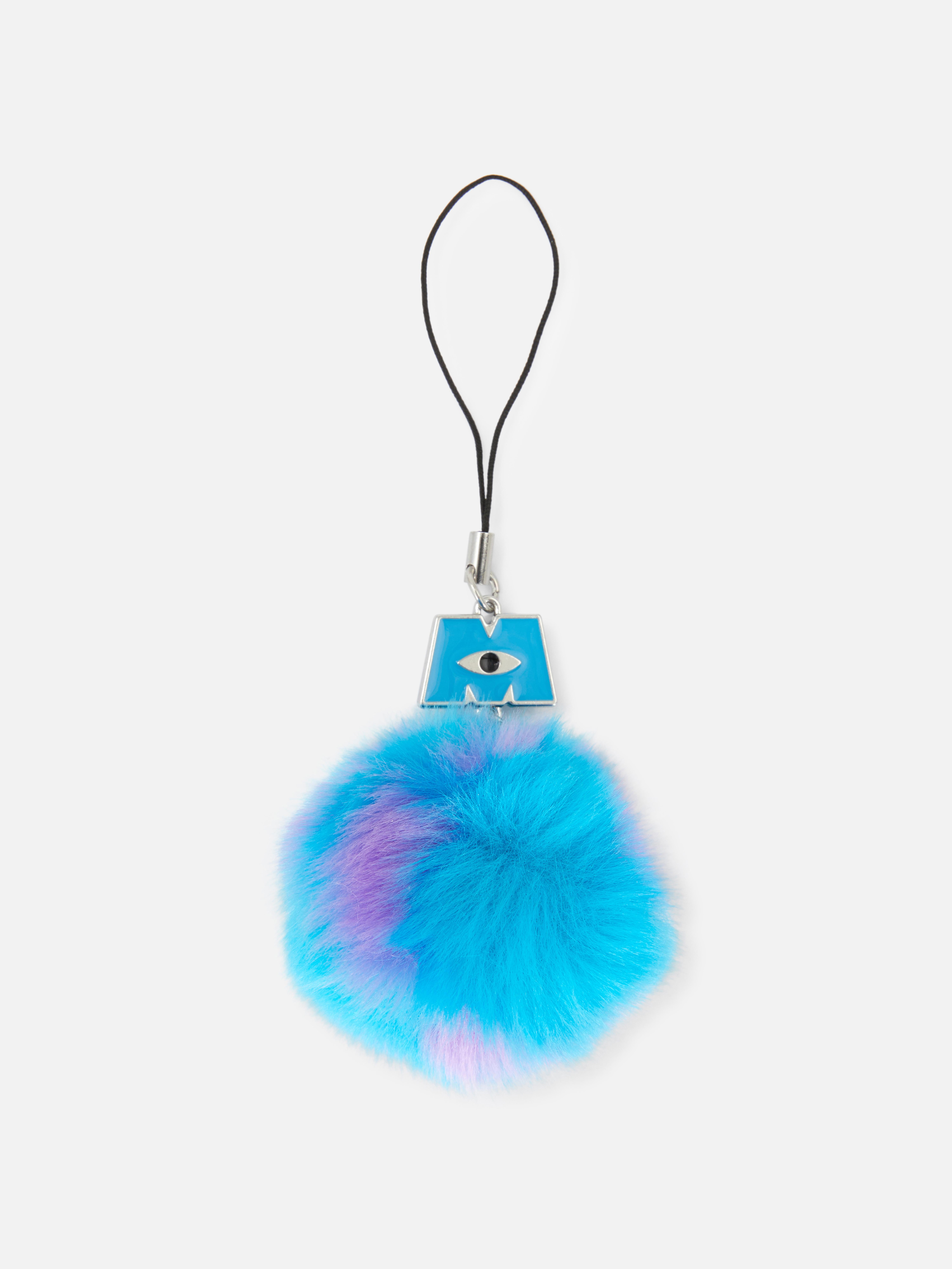 Disneys Monster AG Handy-Anhänger. Ein Handy-Anhänger mit einem flauschigen Bommel und dem Logo von Monster AG.