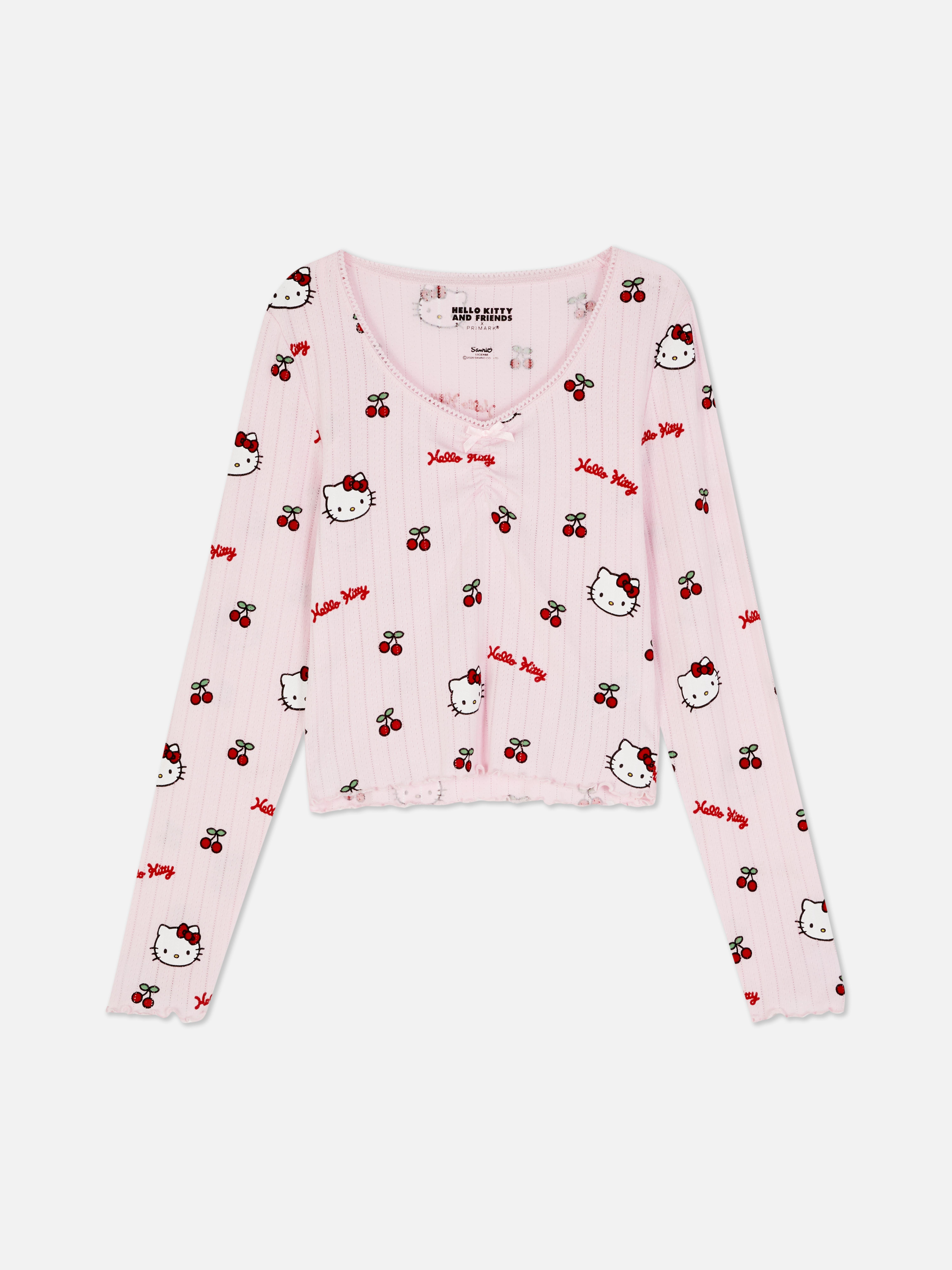Top de pijama cu mânecă lungă și imprimeu Hello Kitty ajurat Un top de pijama Hello Kitty cu mâneci lungi, ajurat, garnitură picot și tiv festonat