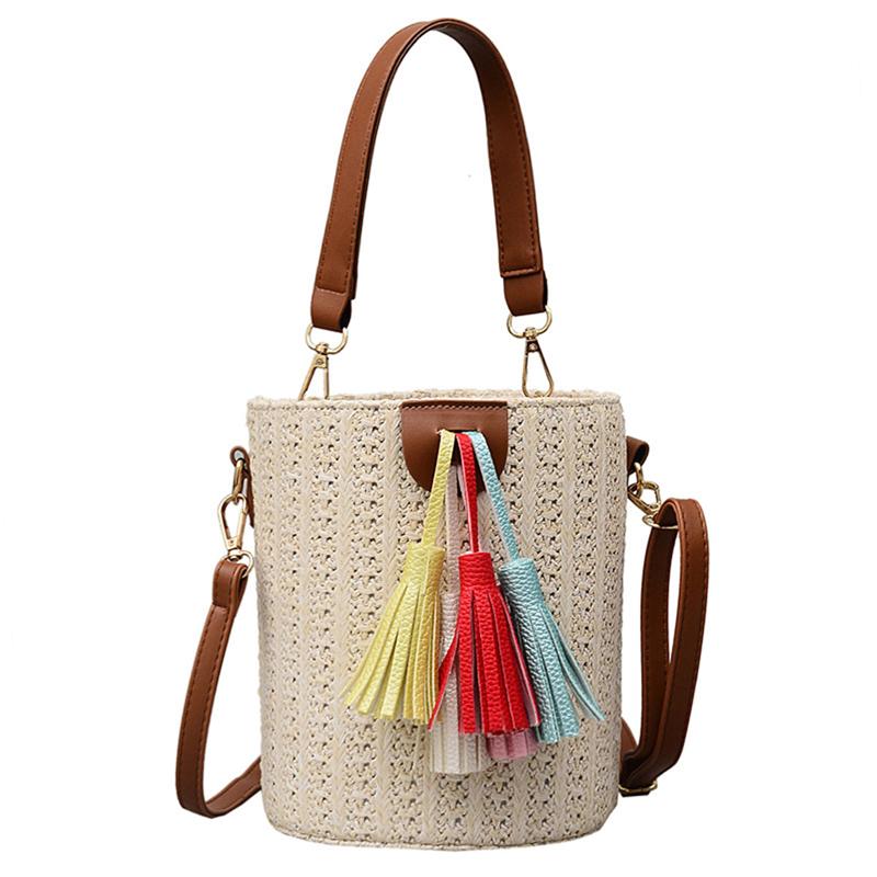 Tendance mode 2020 pour les vacances d'été à la plage : Sac seau en paille tressée, bandoulière, pochette à pompons colorés, idéal pour les femmes.