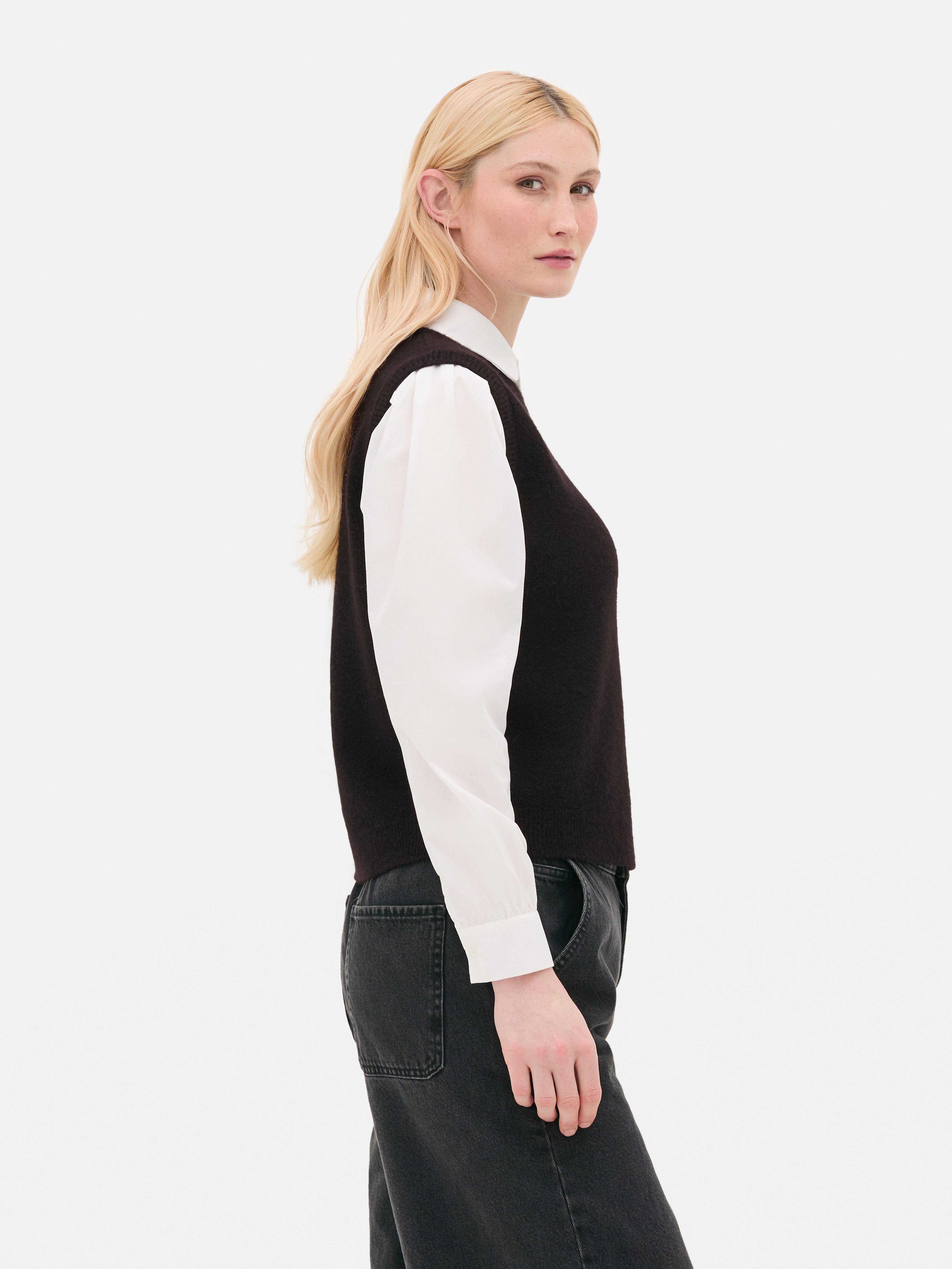 Camicia e gilet 2 in 1. Un gilet in maglia e una camicia con colletto e maniche lunghe con polsini.