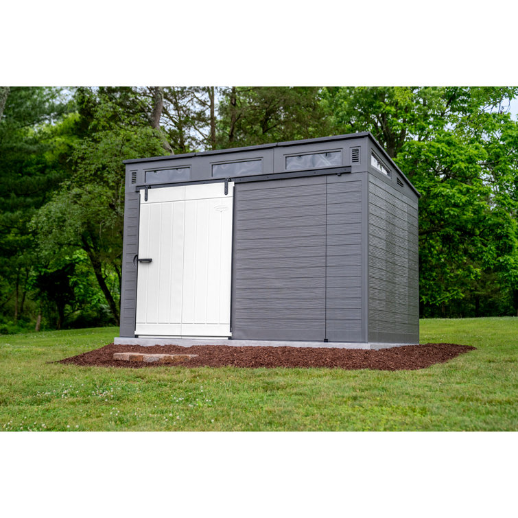 Casinha de armazenamento Suncast Modernist com porta de celeiro, 3,29 m de largura x 2,22 m de profundidade, em resina.