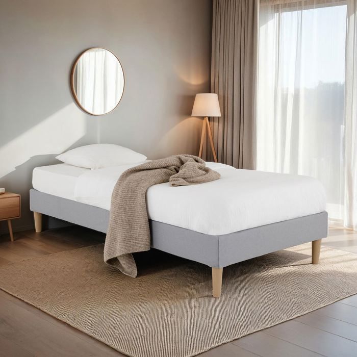 Base de cama tapizada PAIMPOL de 90 x 190 cm, estructura de madera y revestimiento de tela gris, estructura de cama con patas.