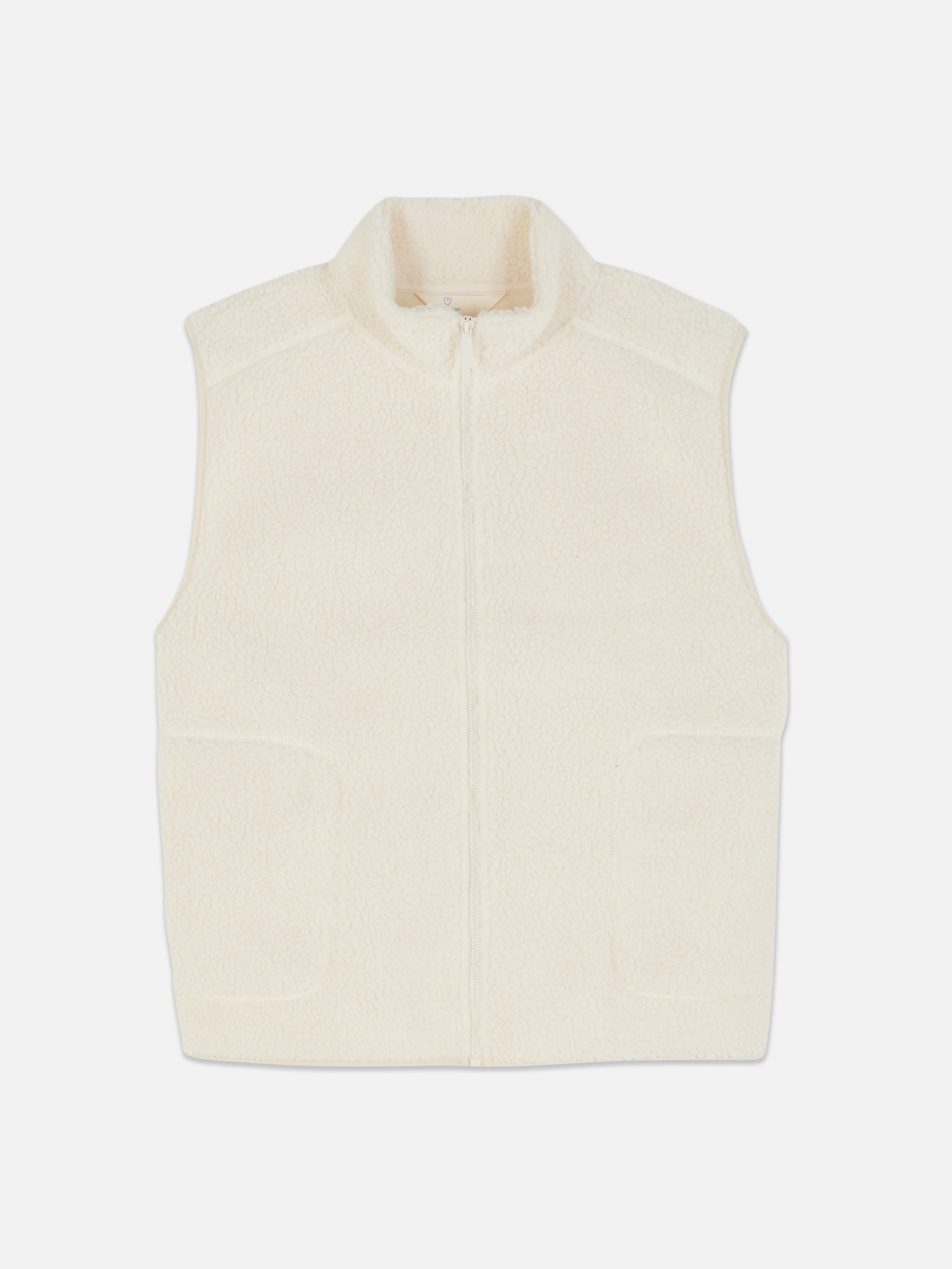 Vestă de corp din fleece cu fermoar. Vestă de corp moale, fără mâneci, cu guler ridicat și fermoar.