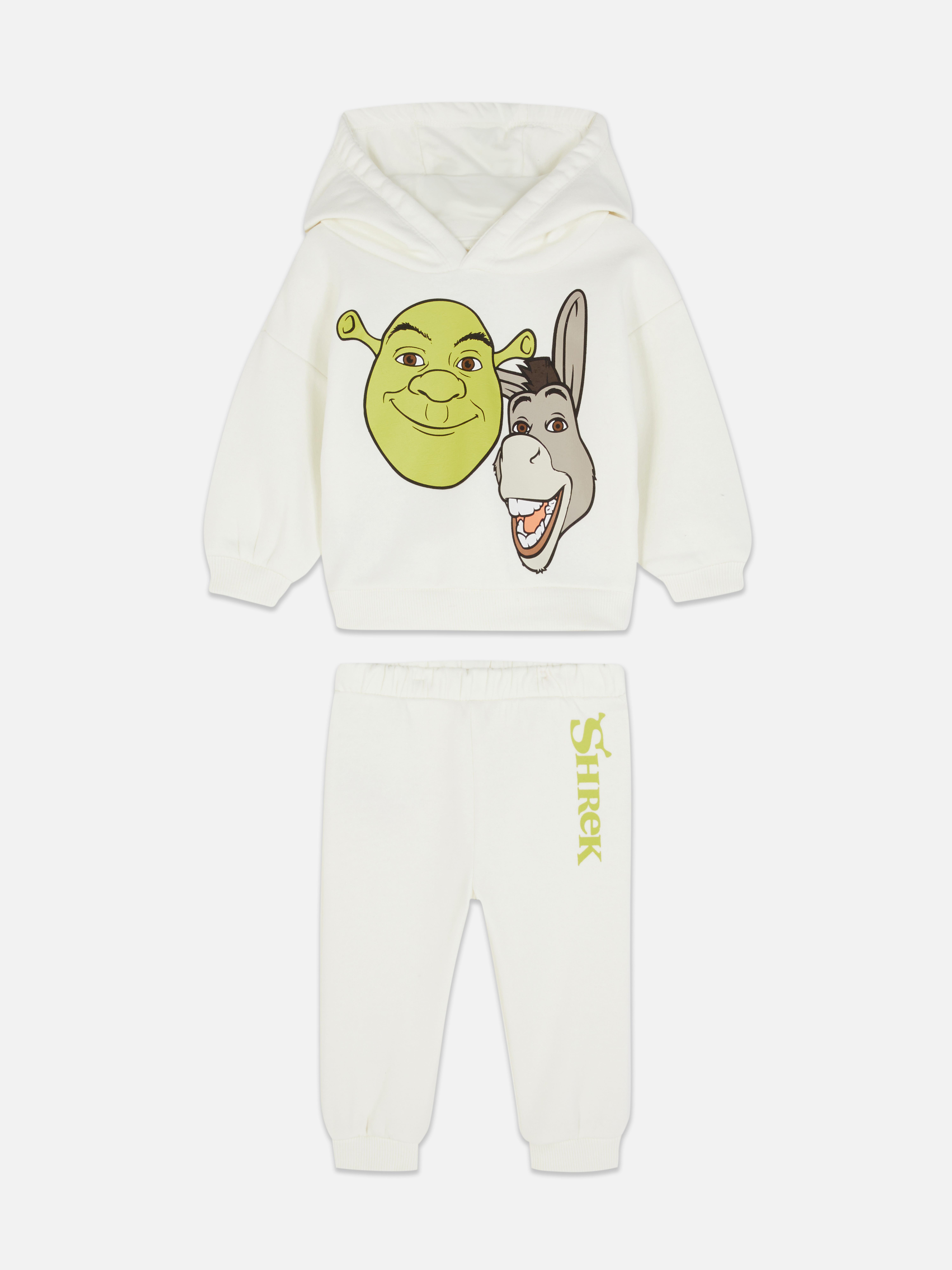 Hanorac și pantaloni de trening asortați cu tematică Shrek. Un hanorac cu tematică Shrek și pantaloni de trening asortați cu manșete la gleznă.