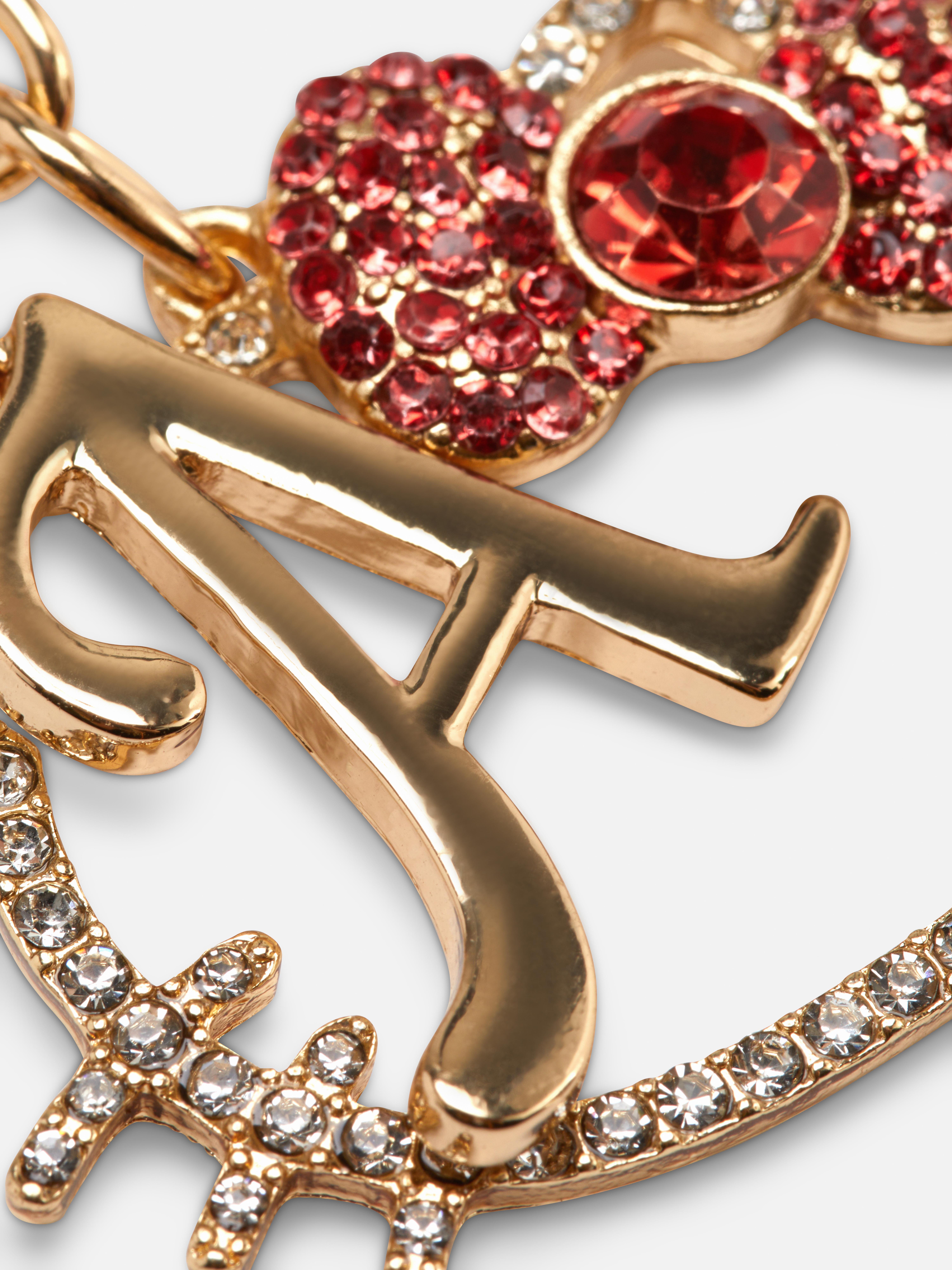 Schlüsselanhänger mit Initial und Hello-Kitty-Anhänger. Dieser Strass-Schlüsselanhänger ist mit einem Hello-Kitty-Anhänger und einem Initial verziert.