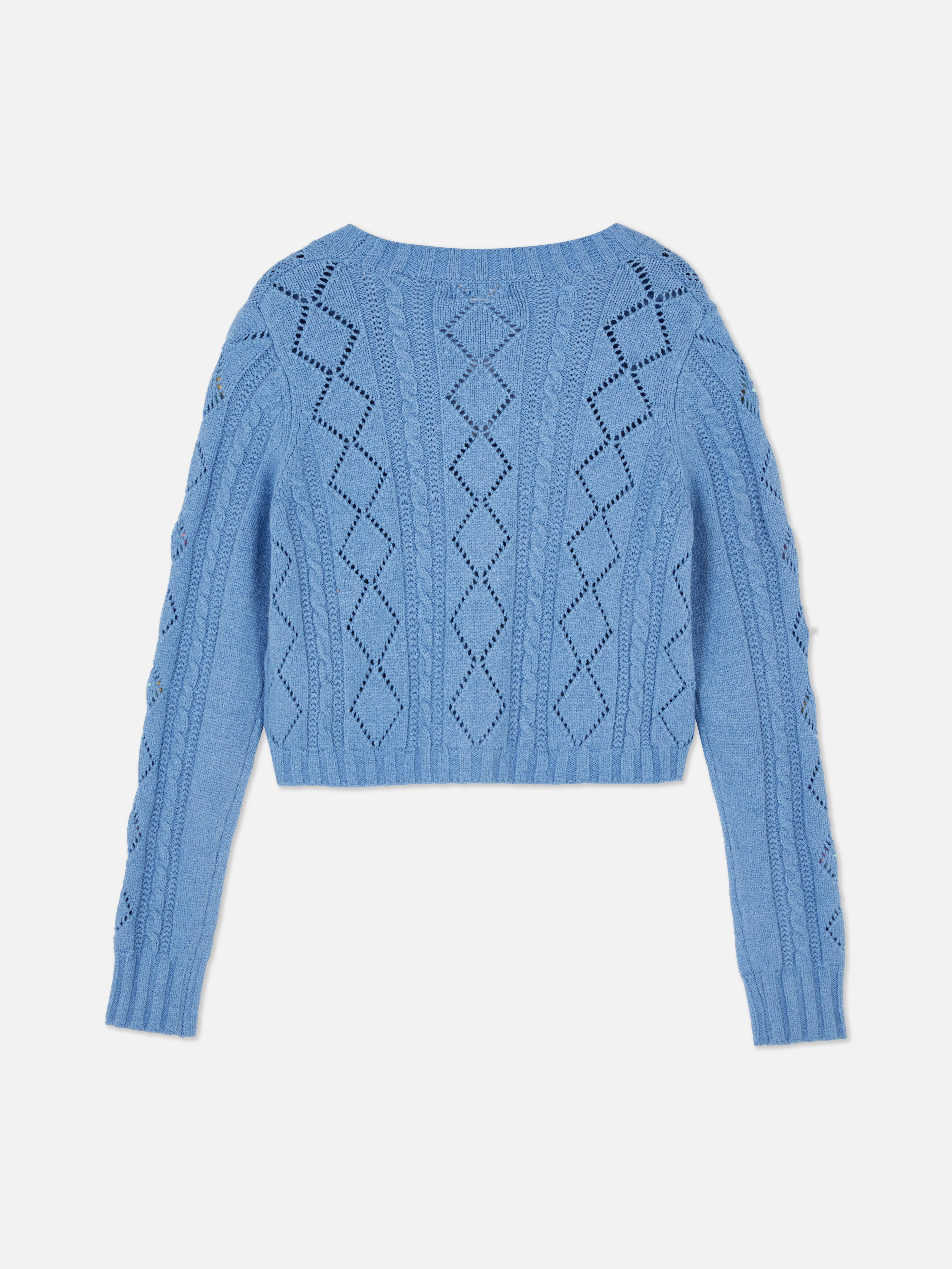 Embroidered V-neck cardigan Knitted cardigan with V-neck, button closure, and lively embroidered details