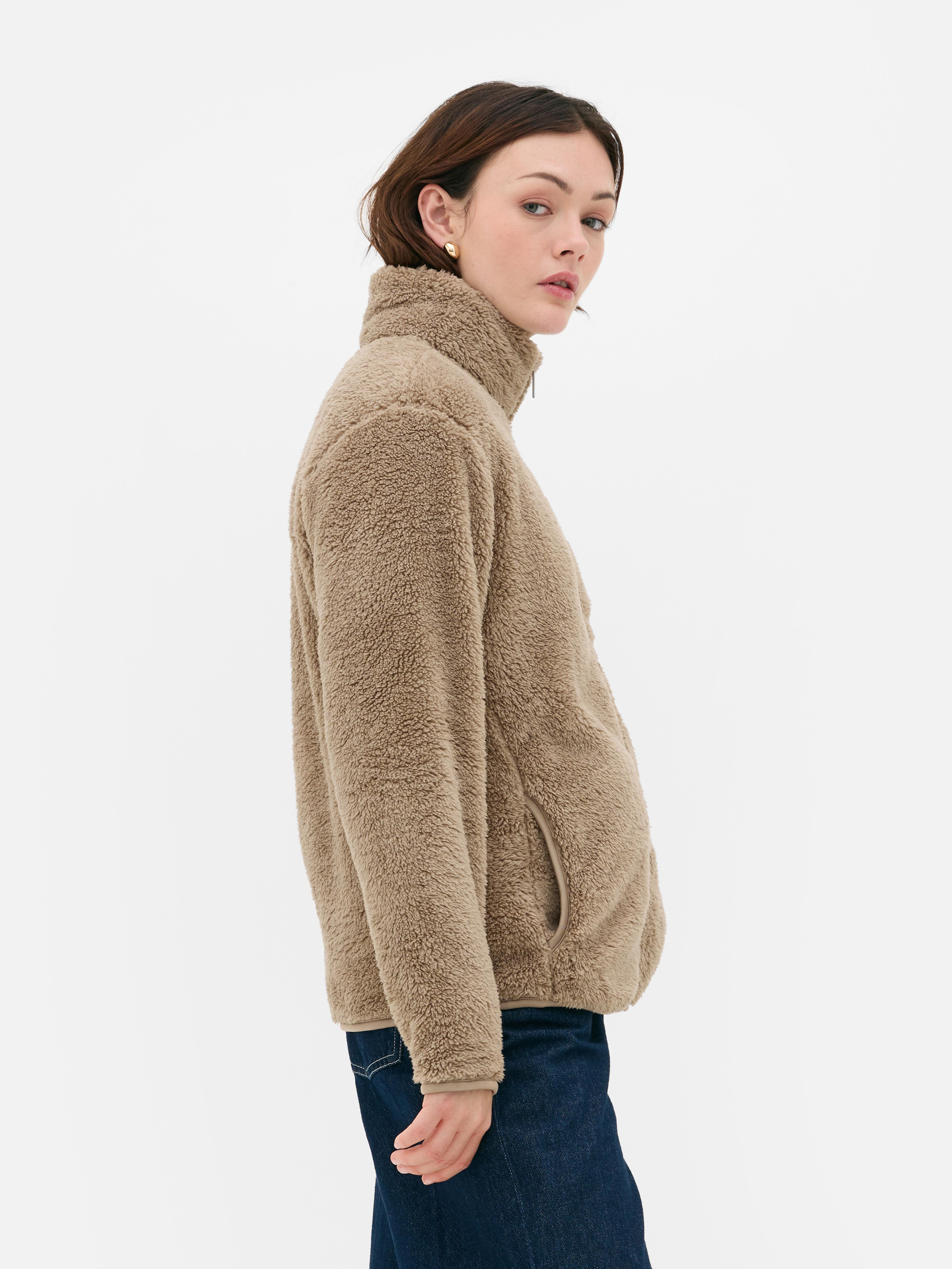 Teddy fleece zippered jacket. A soft teddy fleece jacket with long sleeves, a stand-up collar, and a full-length zipper.