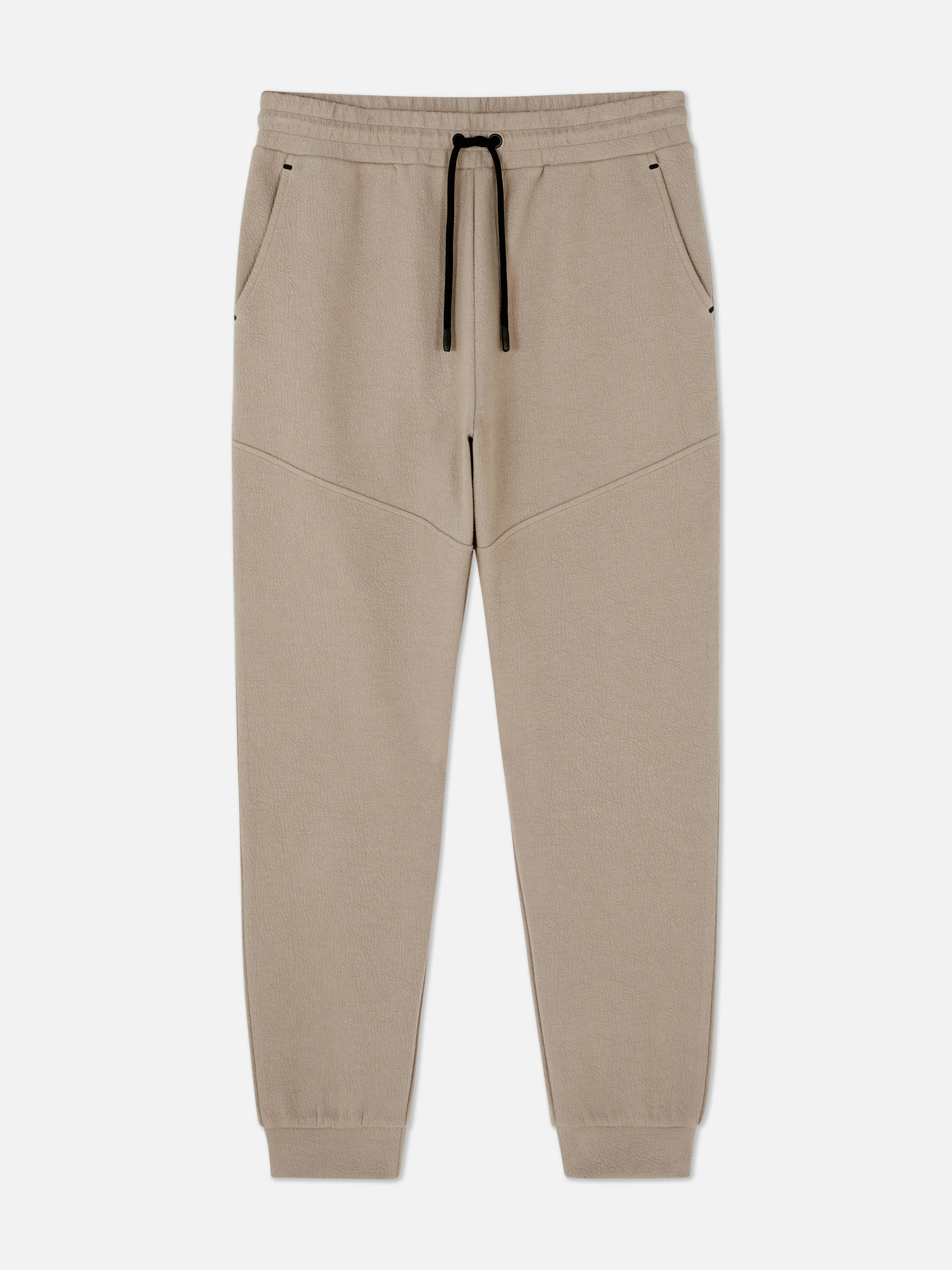 Pantaloni de trening texturați cu șnur de strângere Pantaloni de trening cu șnur de strângere, buzunare laterale, clinuri și manșete la gleznă