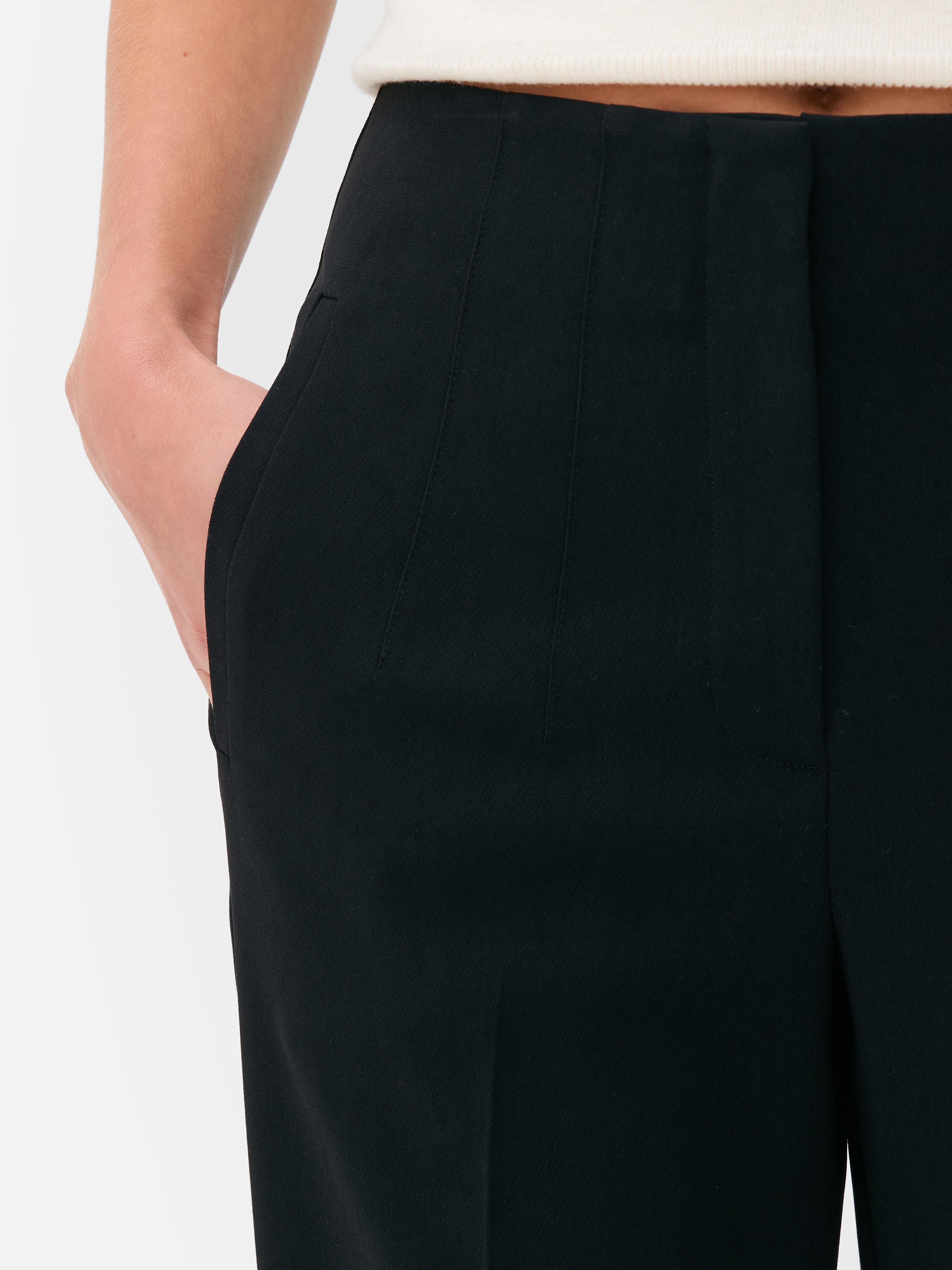 Hochgeschnittene Hose mit Bundfalten. Diese klassische, hochgeschnittene Hose zeichnet sich durch Bundfalten und Bügelfalten aus.