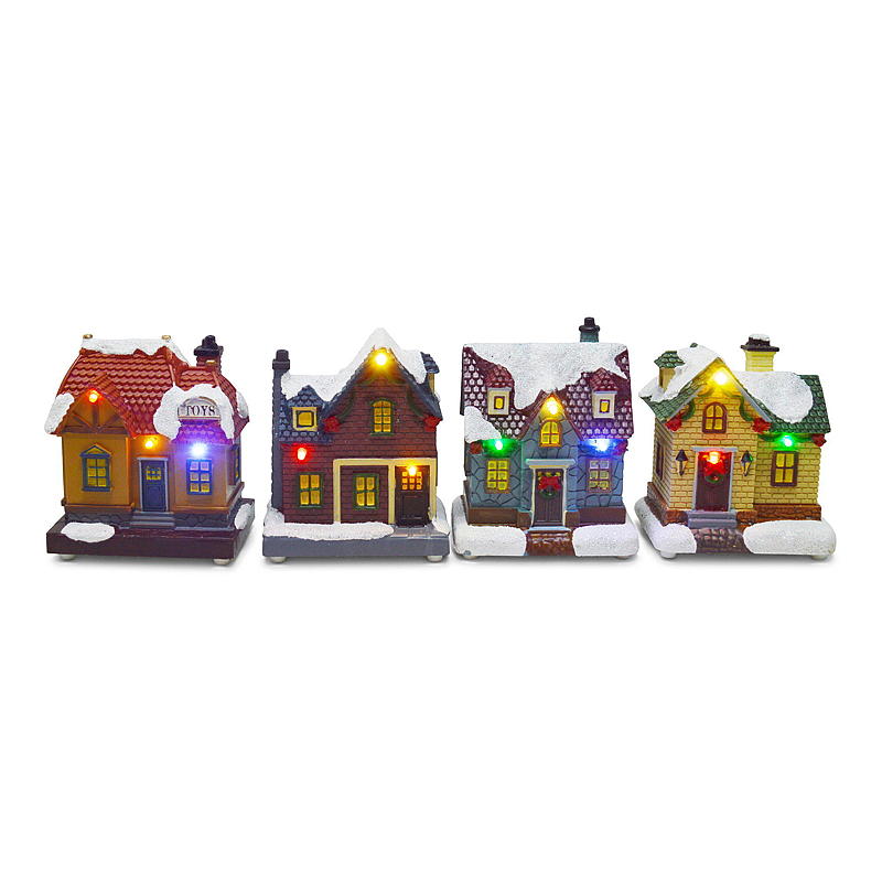 Pueblo navideño casero con cabañas iluminadas