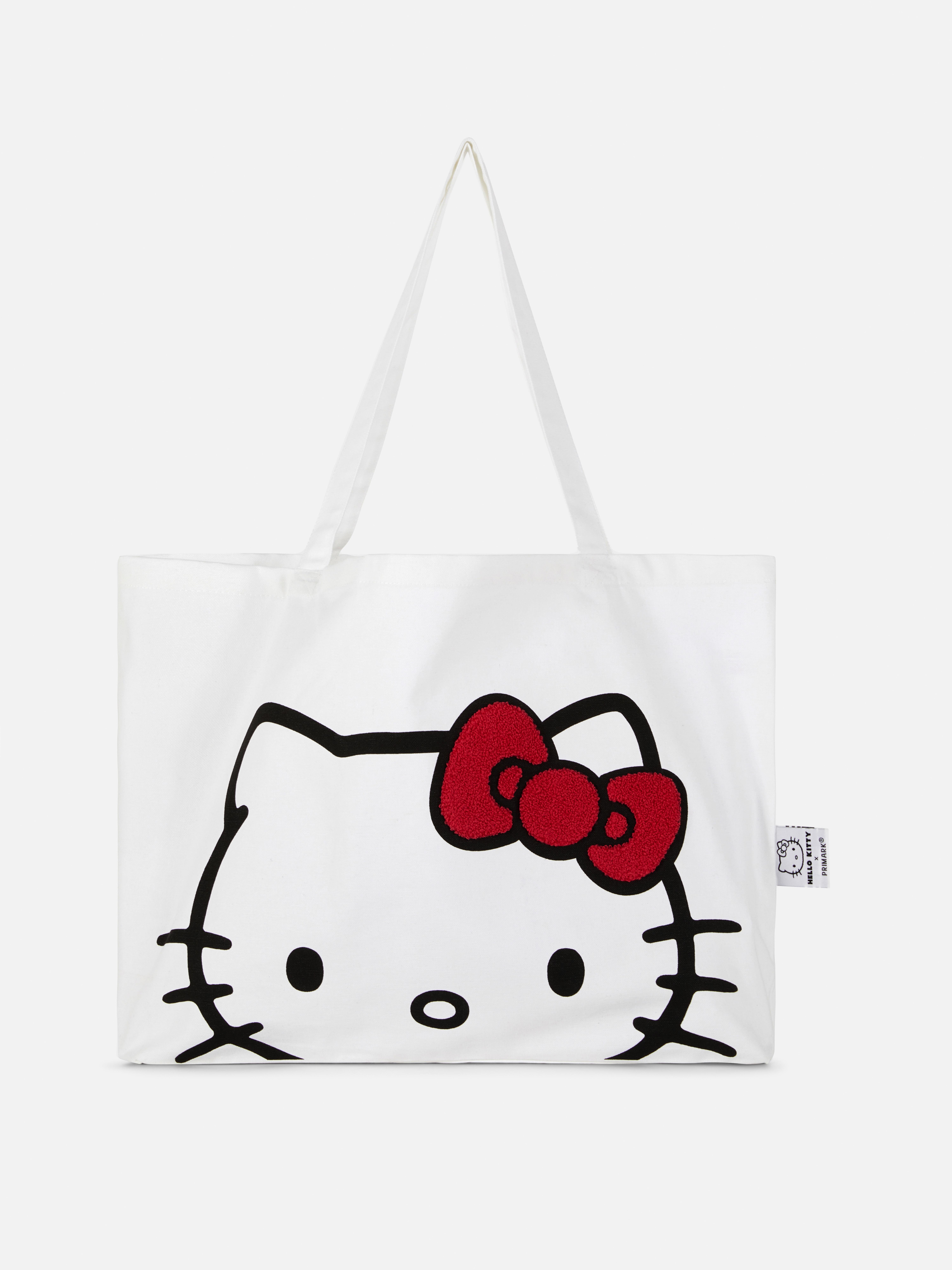 Hello Kitty vászontáska Hello Kitty vászontáska vállpántokkal és buklé díszítéssel