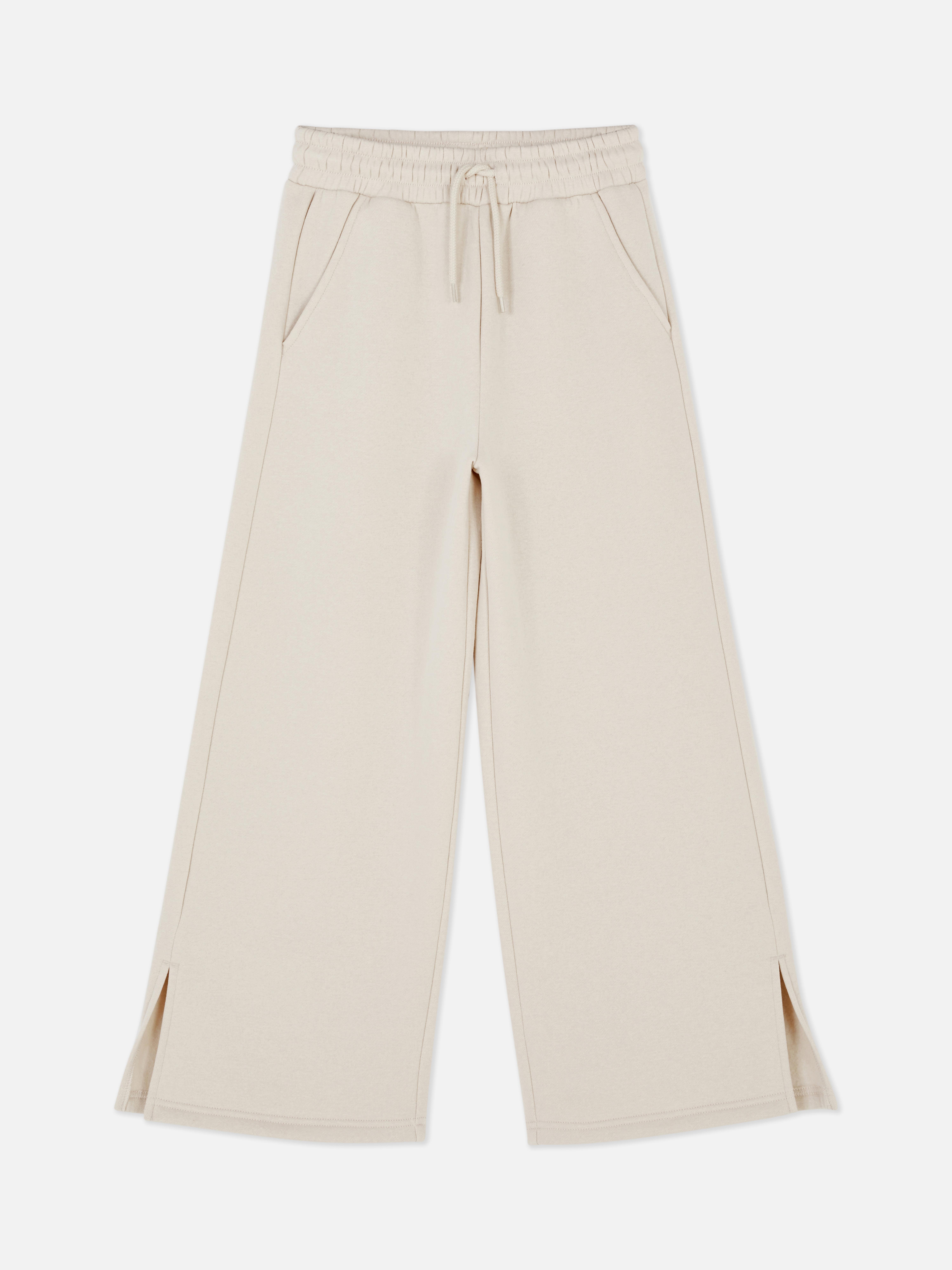 Φόρμα με φαρδιά μπατζάκια Αυτή η φόρμα έχει φαρδιά μπατζάκια με σχισμή, ζώνη με κορδόνι και τσέπες
