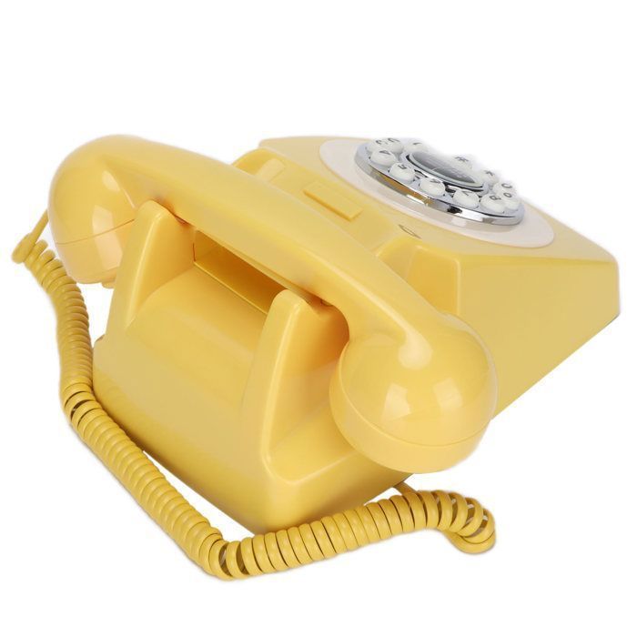Teléfono fijo clásico retro con cable en color amarillo, estilo vintage, para telefonía doméstica y decoración de interiores.