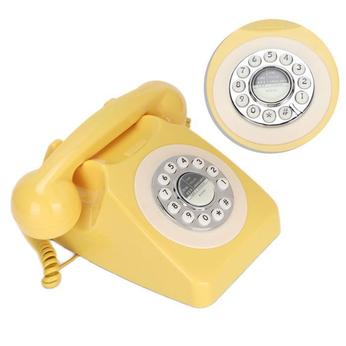 Telefone fixo clássico retrô com fio na cor amarela, estilo vintage, para telefonia residencial e decoração de interiores.