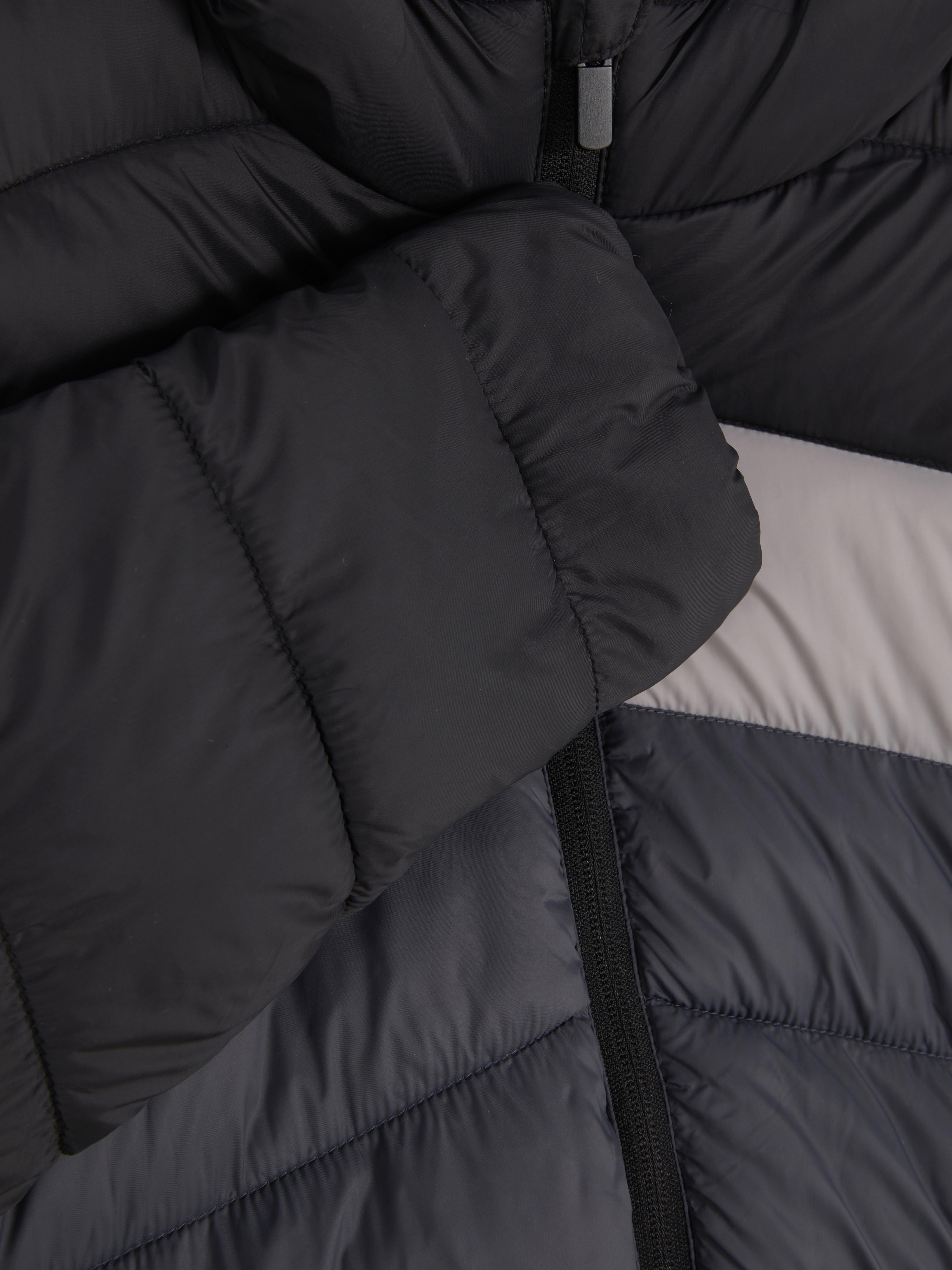 Gefütterte Jacke mit Farbblöcken. Diese Kapuzen-Steppjacke hält Ihr Kind schön warm und sieht dabei auch noch stylisch aus.