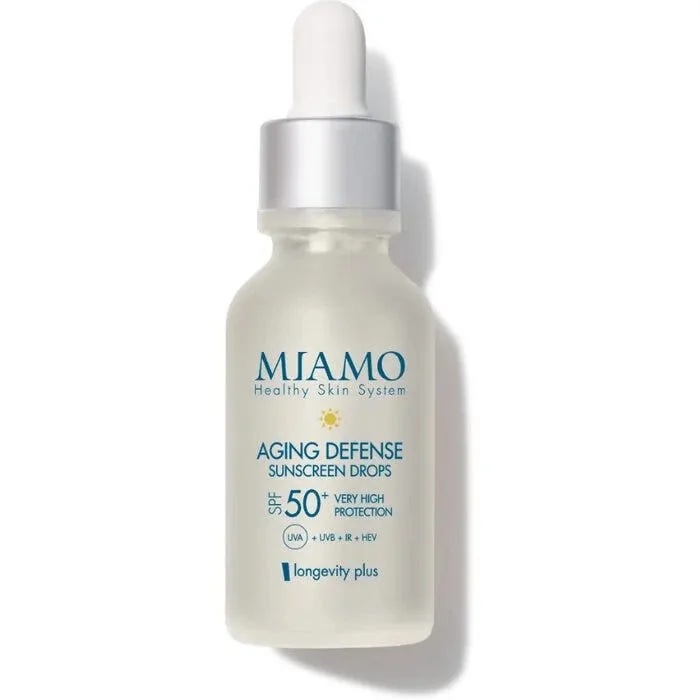 Gotas protectoras solares MIAMO Aging Defense SPF 50+ con efecto iluminador dorado.