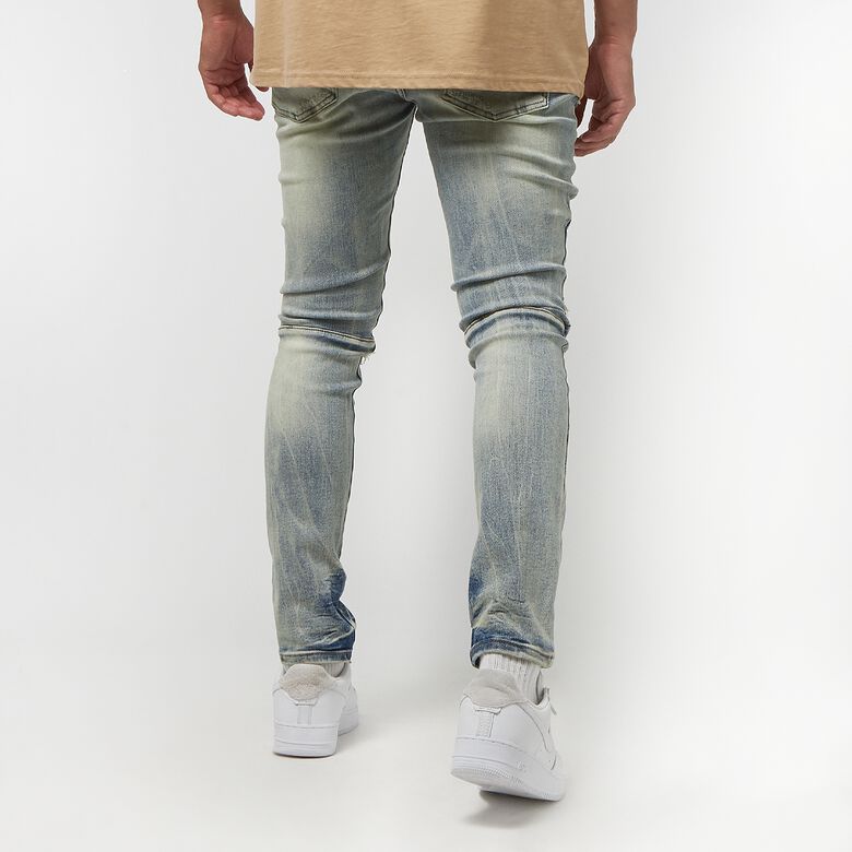 Vintage gewassen jeans met scheuren en reparaties