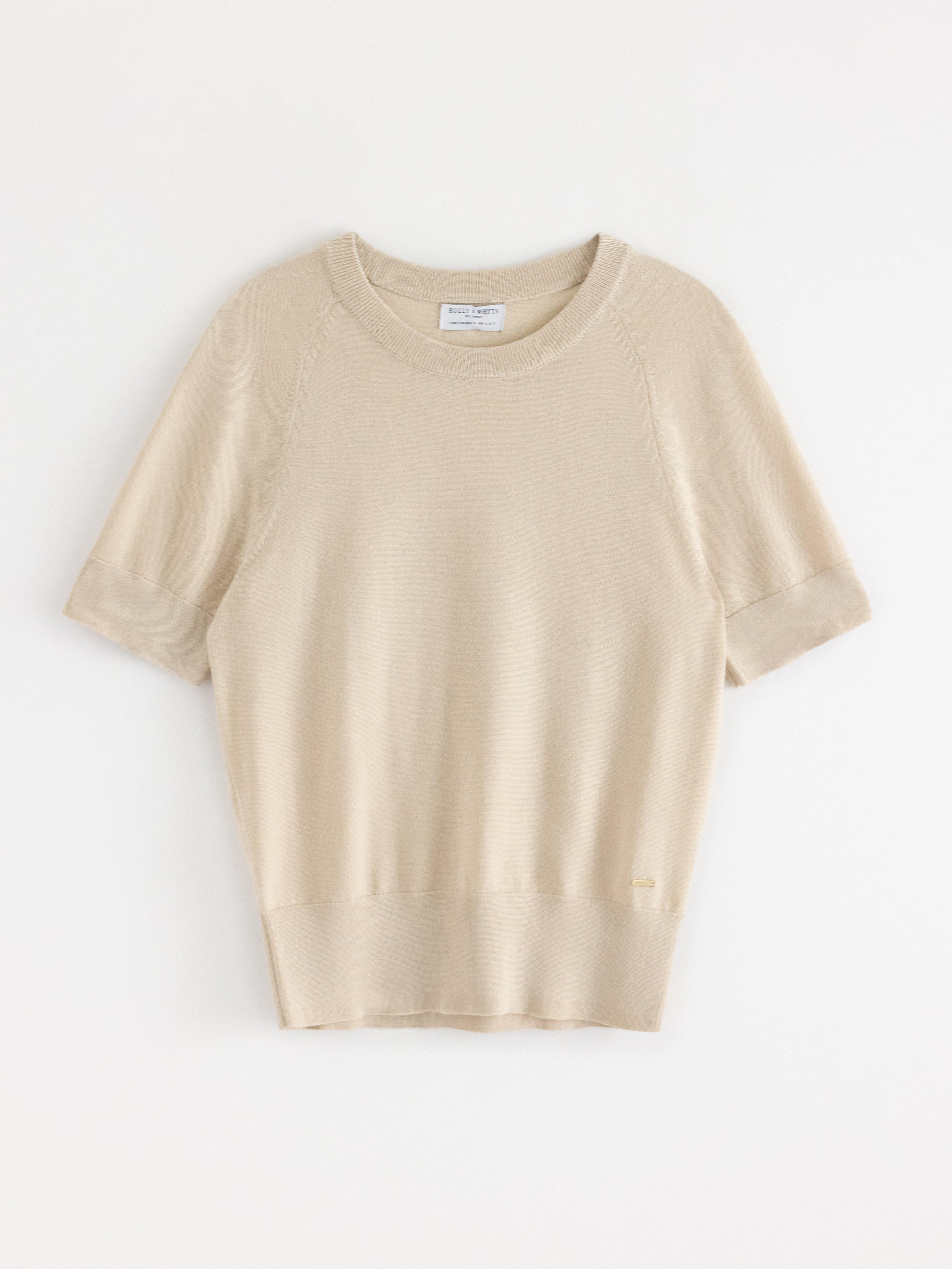 Jersey de punto fino color beige claro.
