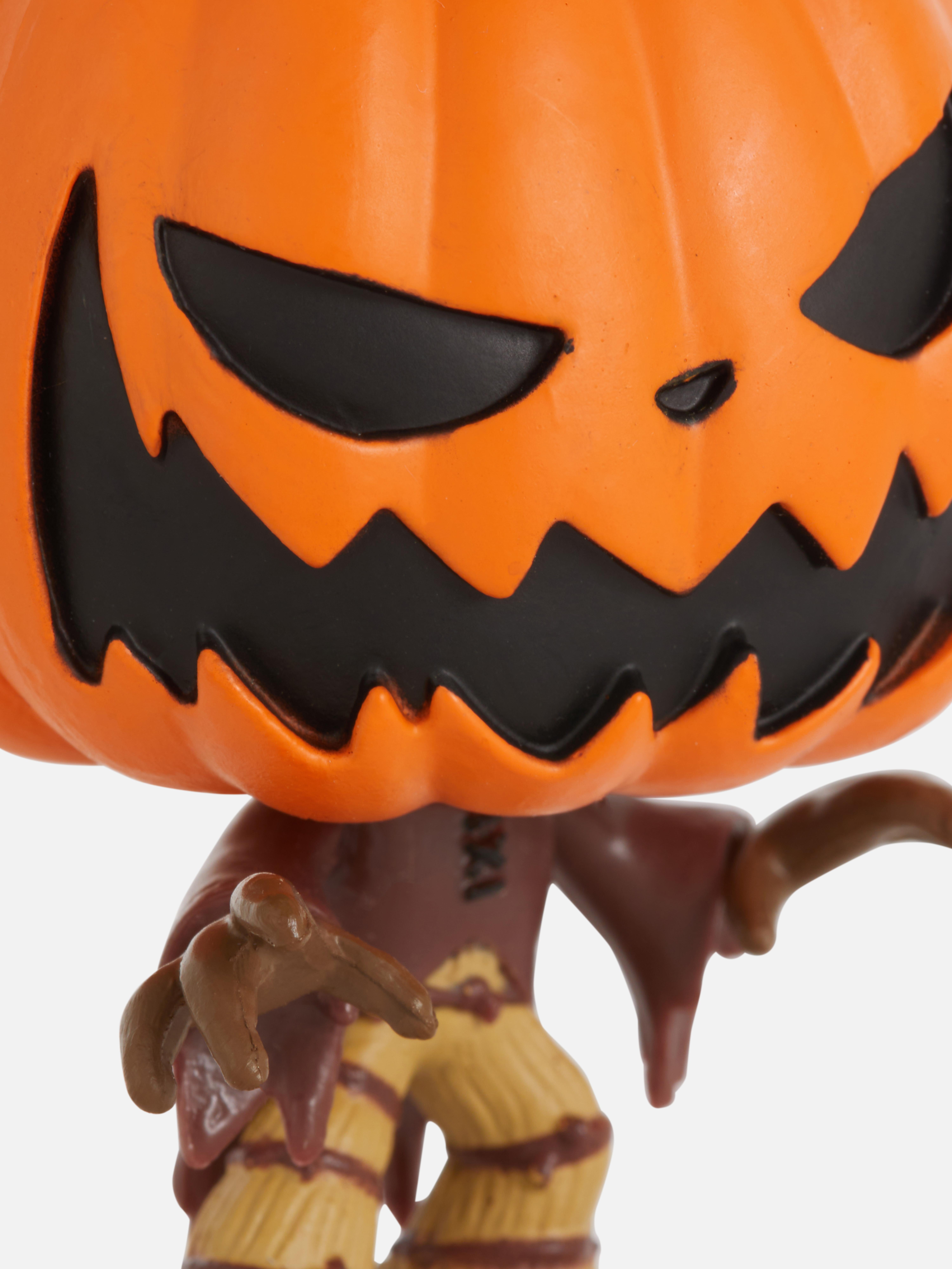 Figurină Funko Minis Disney Coșmarul dinaintea Crăciunului. O figurină Regele Dovleac într-un ambalaj cadou înfricoșător.