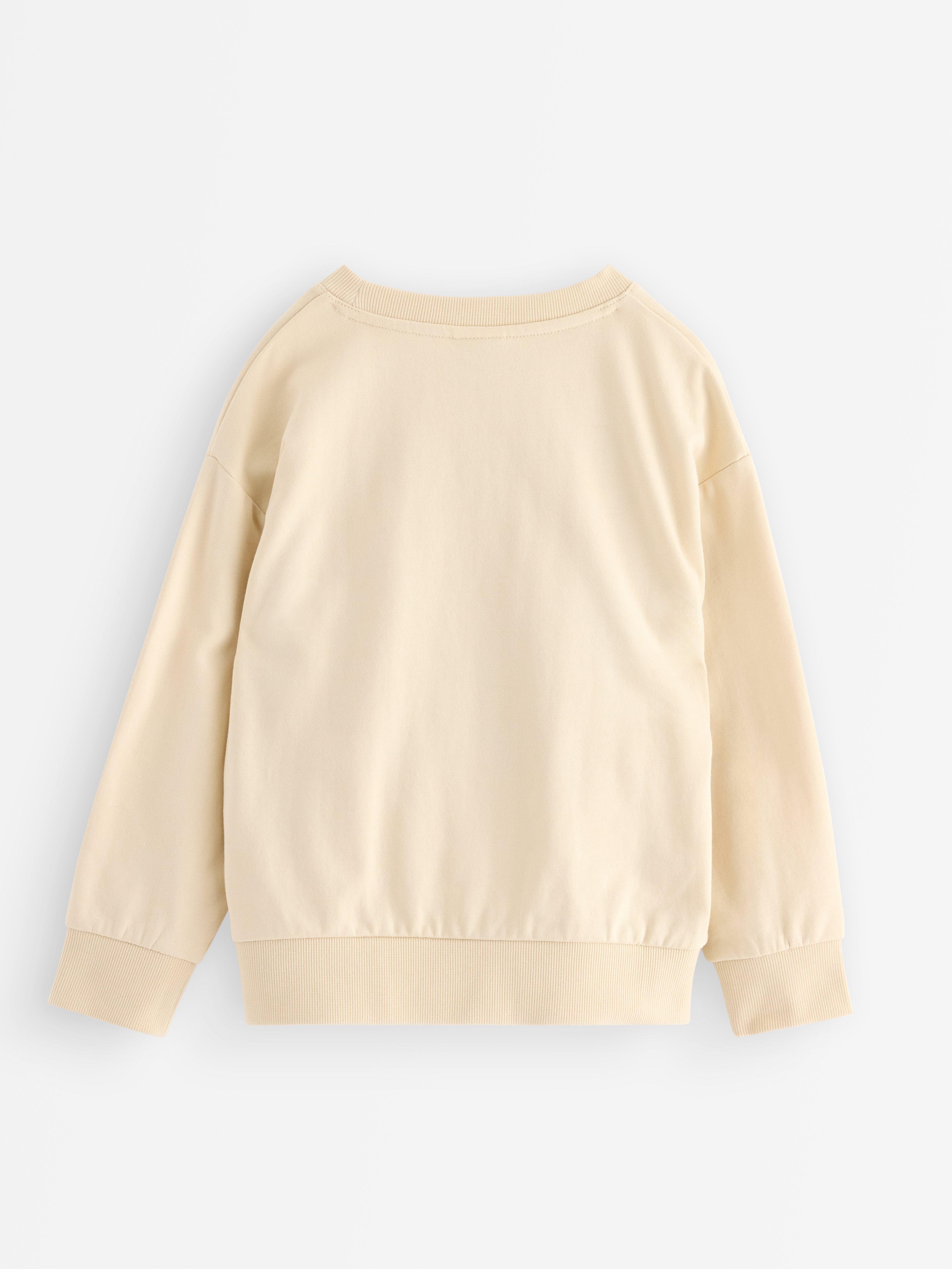 Sudadera Pokémon color beige claro