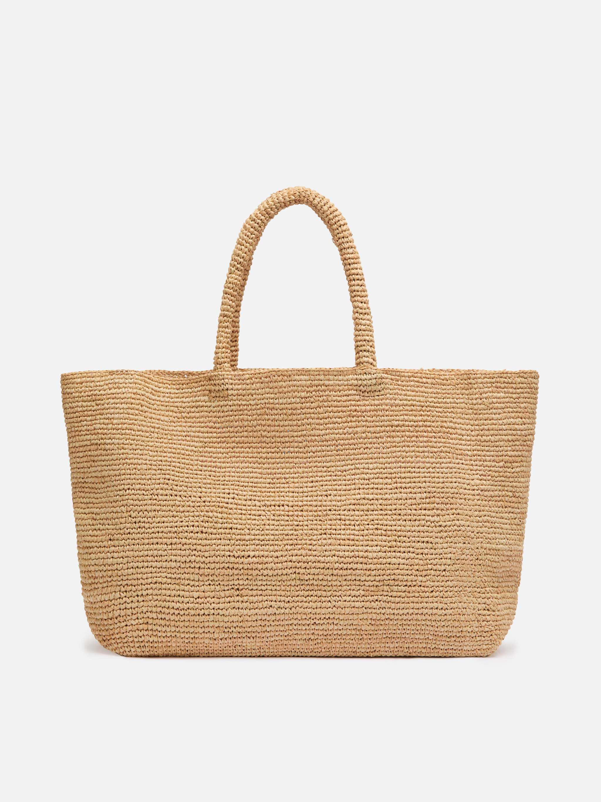 Beige raffia strandtas met katoenen binnenvak en St. Trop-borduurwerk.