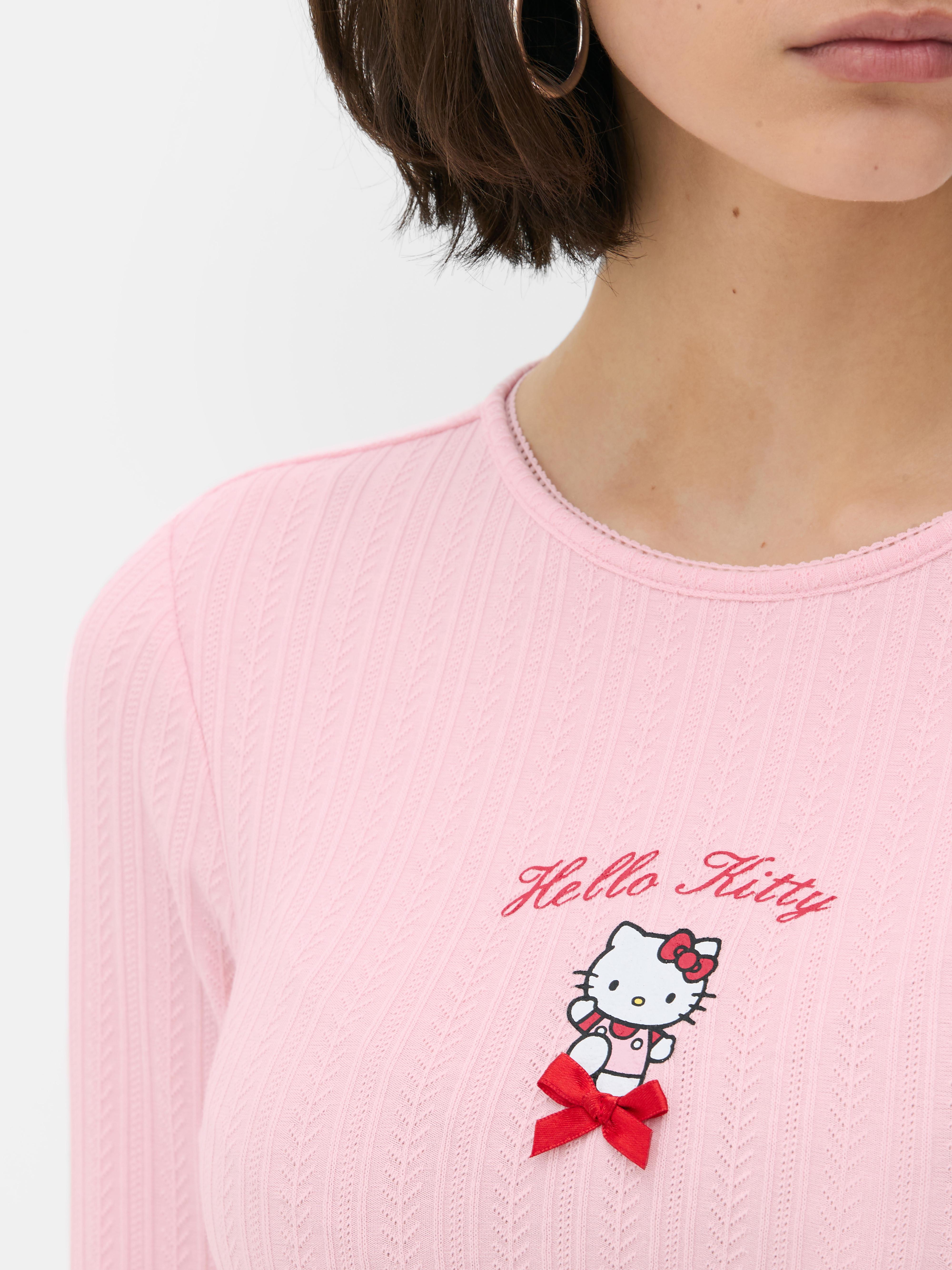 Tricou cu mânecă lungă și imprimeu Hello Kitty ajurat Un tricou cu imprimeu Hello Kitty, mânecă lungă și ajurat