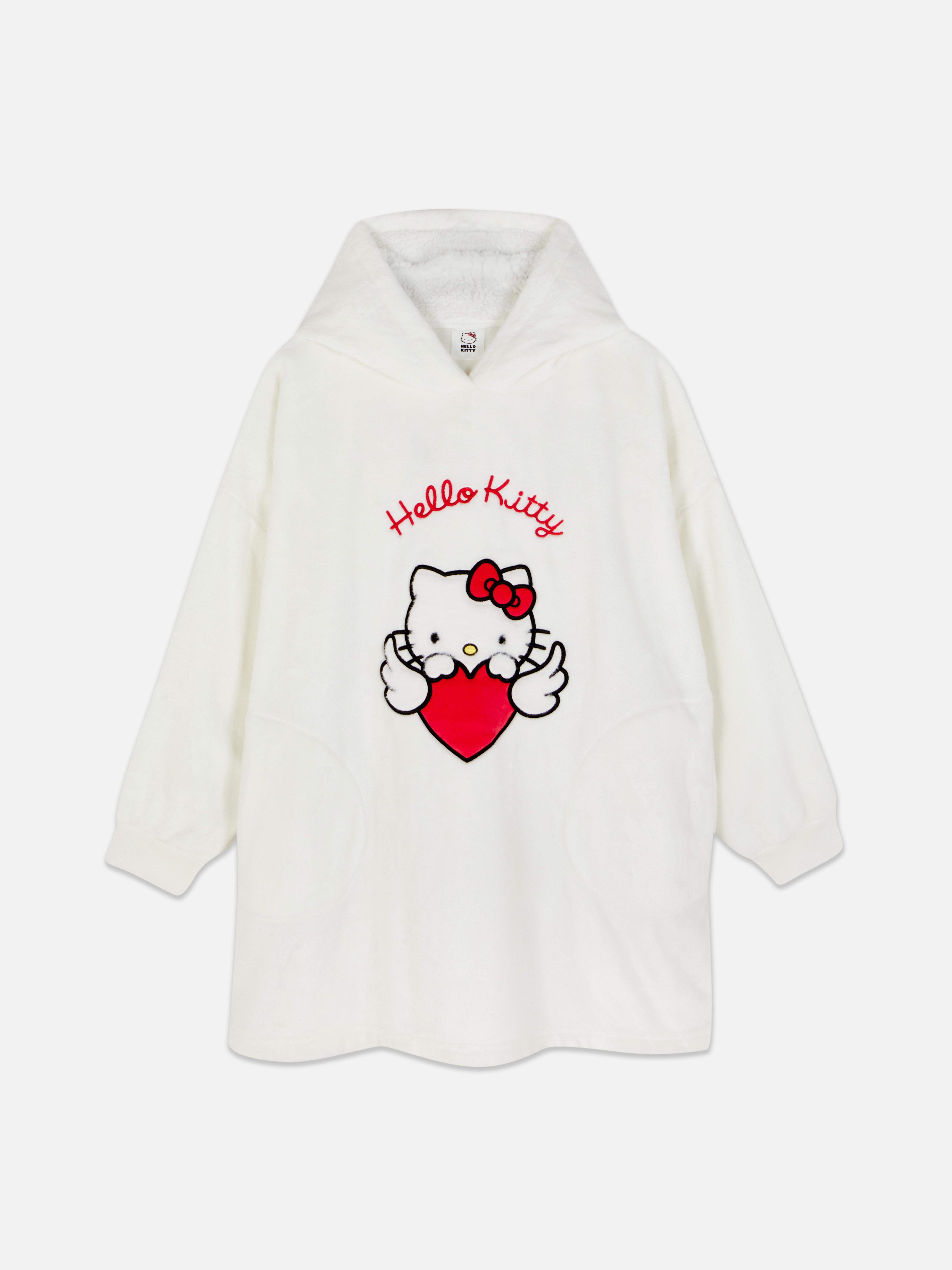Snuddie Hello Kitty O snuddie Hello Kitty cu glugă, urechi decorative și fundă roșie emblematică