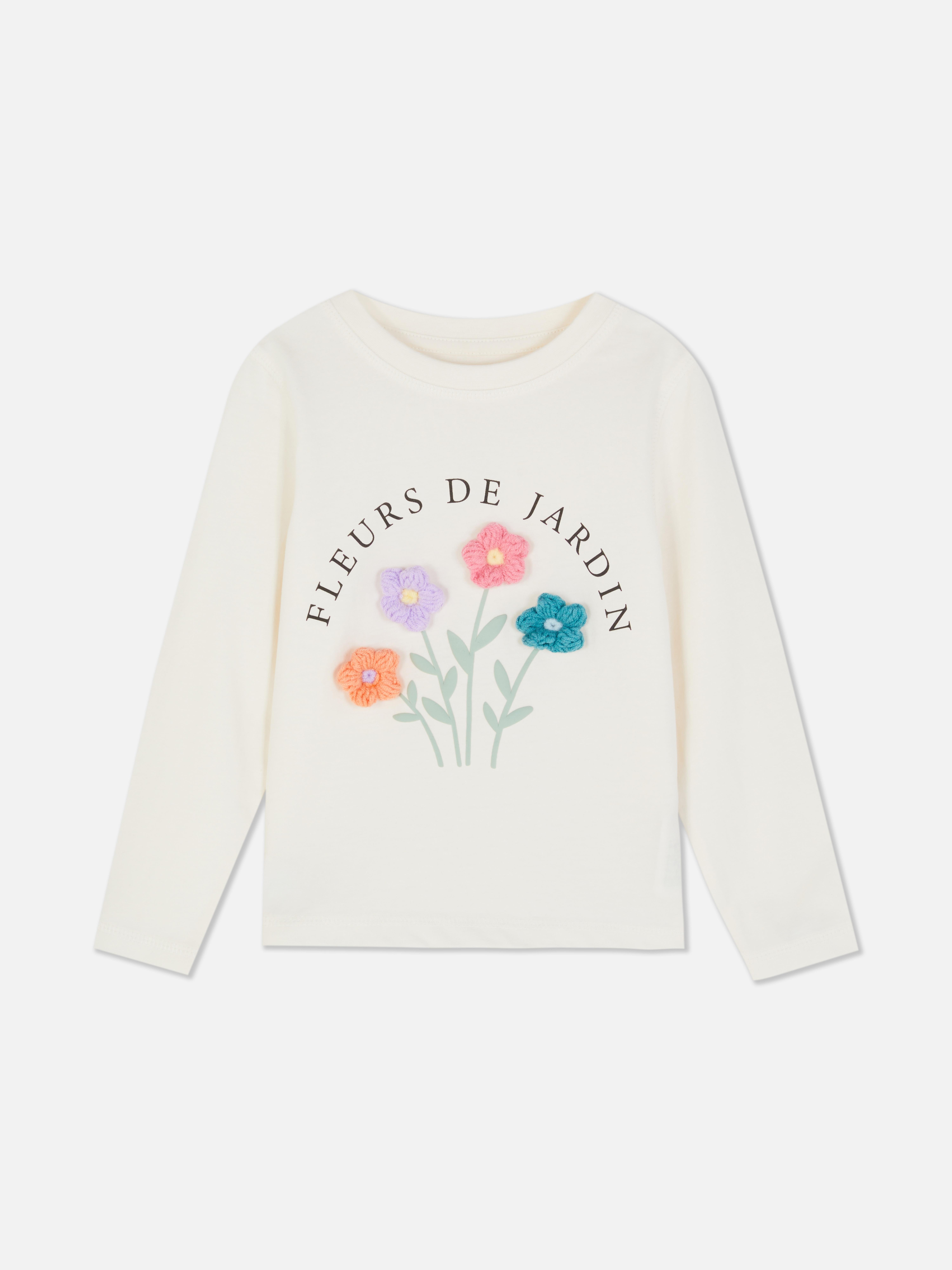 T-shirt à manches longues à motif floral. Un T-shirt à manches longues orné d'un motif floral sur le devant.
