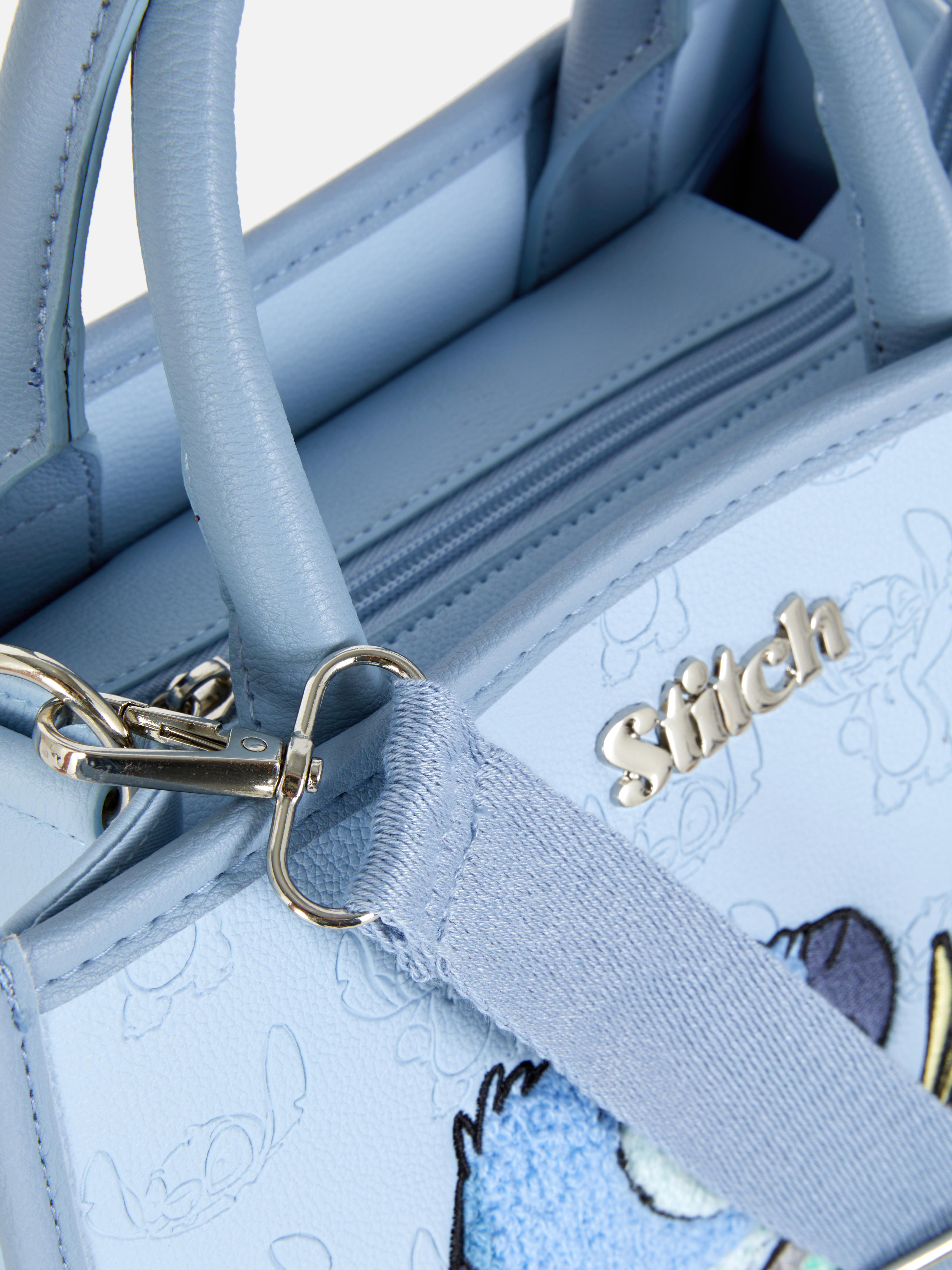 Disney Stitch Schultertasche: Eine blaue Tragetasche mit abnehmbarem Schultergurt und Stitch- und Scrum-Motiv.