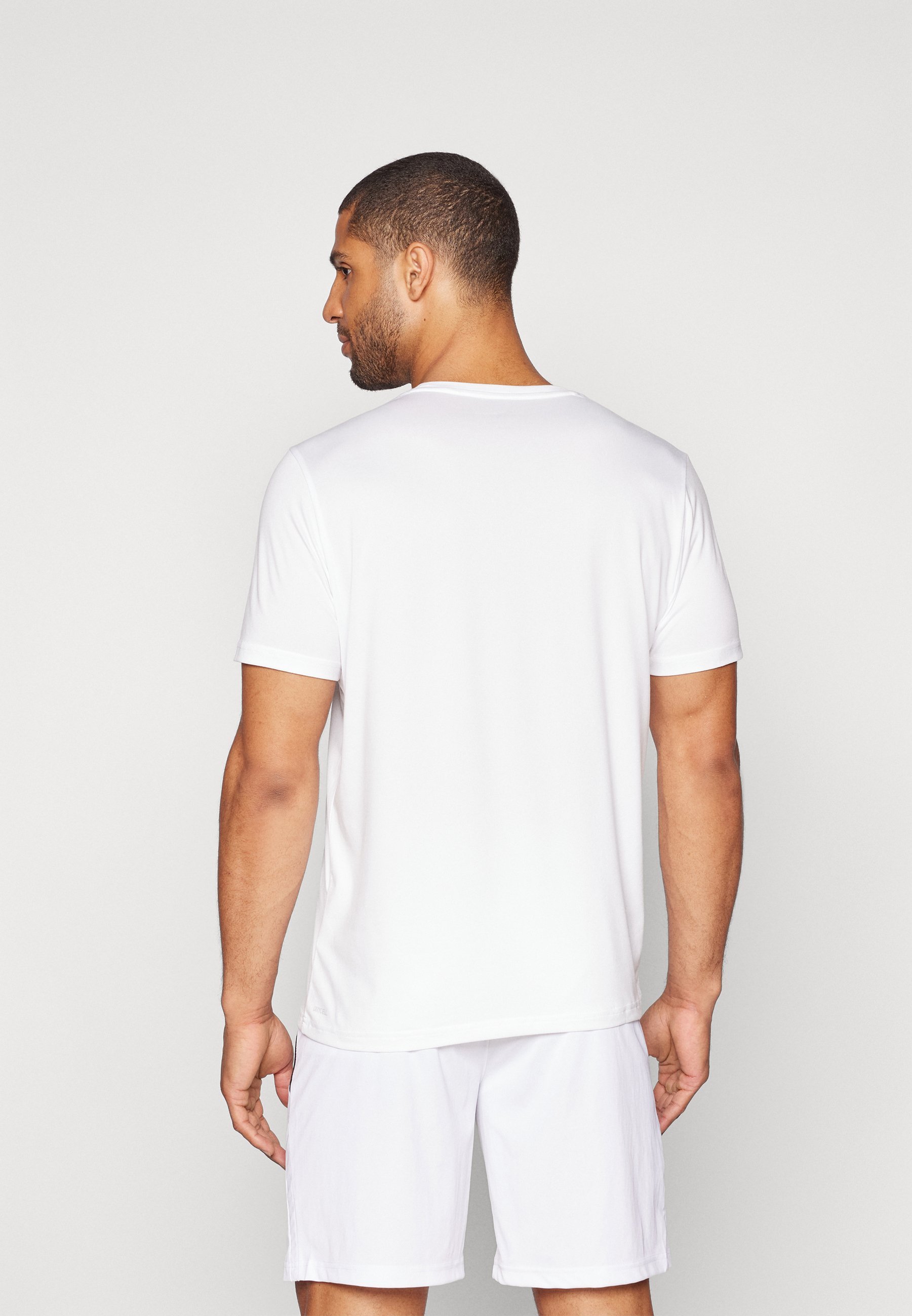 Puma ESSENTIALS SOLID CAT TEE - Sport T-shirt - wit