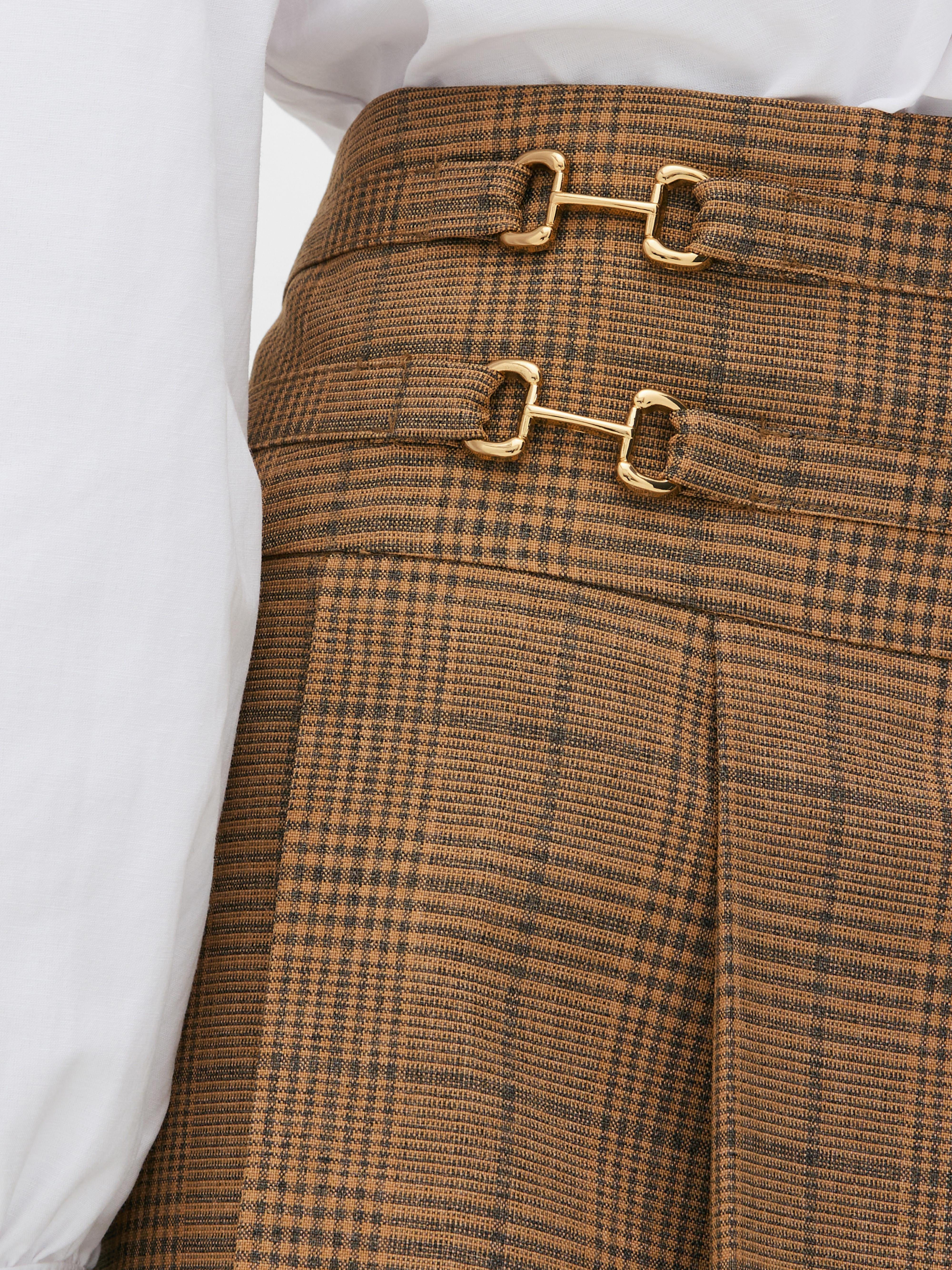 Pleated mini skirt A pleated mini skirt with metallic bit details