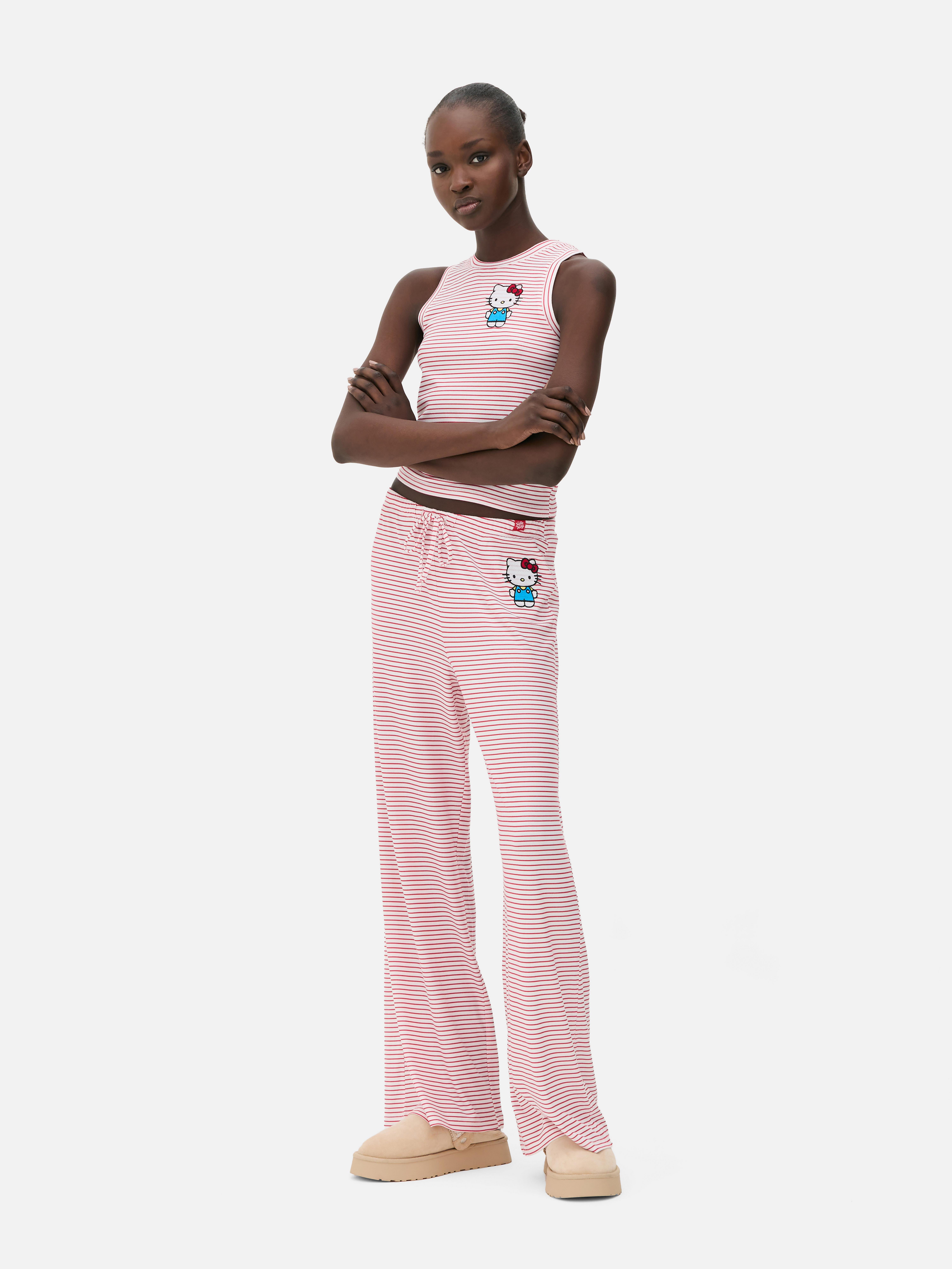Pijama tricotată Hello Kitty and Friends O pijama tricotată cu model în dungi și imprimeu Hello Kitty